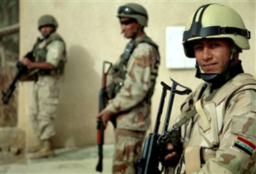 Iraqi soldiers assigned to the 4th Brigade, 9th Iraqi Army Division, stand guard at a checkpoint in Tarmiya, Iraq, Feb. 19, 2008.