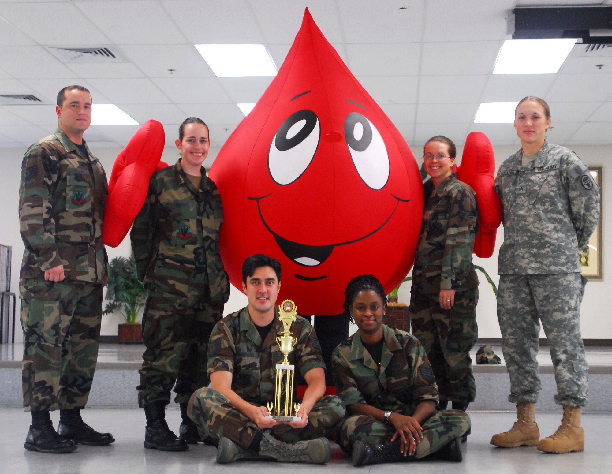 Top Row, L-R Tech. Sgt. Kevin Gilliss, Pacific Air Forces, Hickam Blood Drive Coordinator and unit blood drive managers, Staff Sgt. Malissa Swihart, 352nd Intelligence Operations Squadron, Airman 1st Class Ashley Chappell, 15th Operations Support Squadron, Army Sgt. Palacios, Tripler Army Medical Center. Seated, Tech. Sgt. John Riendeau, Tech. Sgt. Angie Lanier, 692nd Intelligence Group.