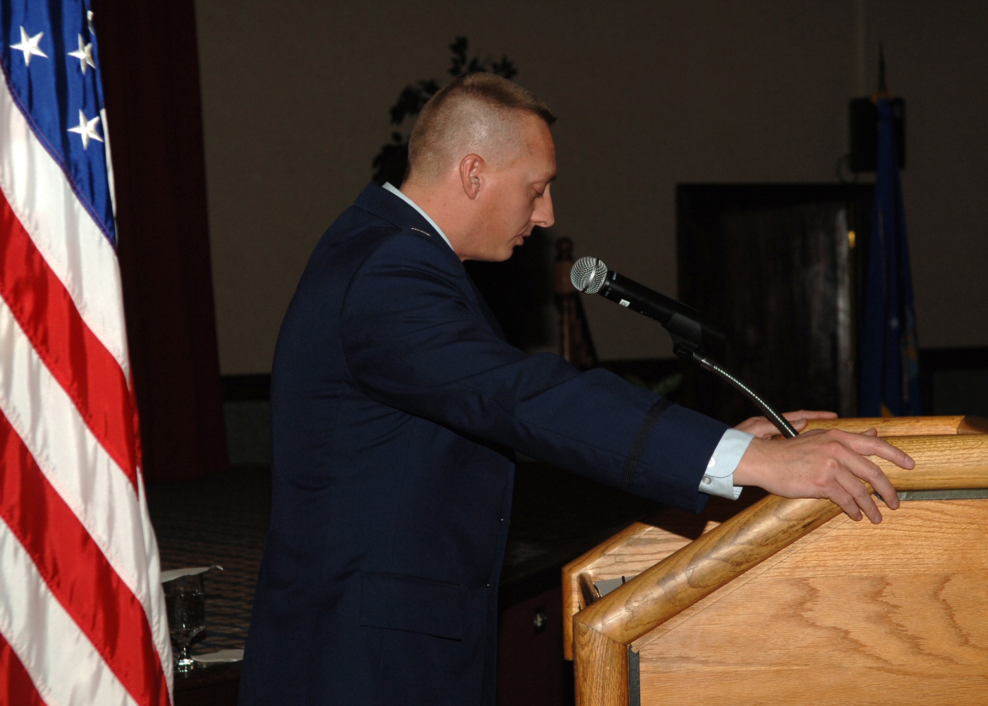 FAIRCHILD AIR FORCE BASE, Wash. – Capt. Mark Williams, 92nd Air Refueling Wing chaplain, bows his head in a prayer for those deployed during the National Prayer Luncheon at Club Fairchild here Feb. 21. (U.S. Air Force photo / Senior Airman Jocelyn Ford)