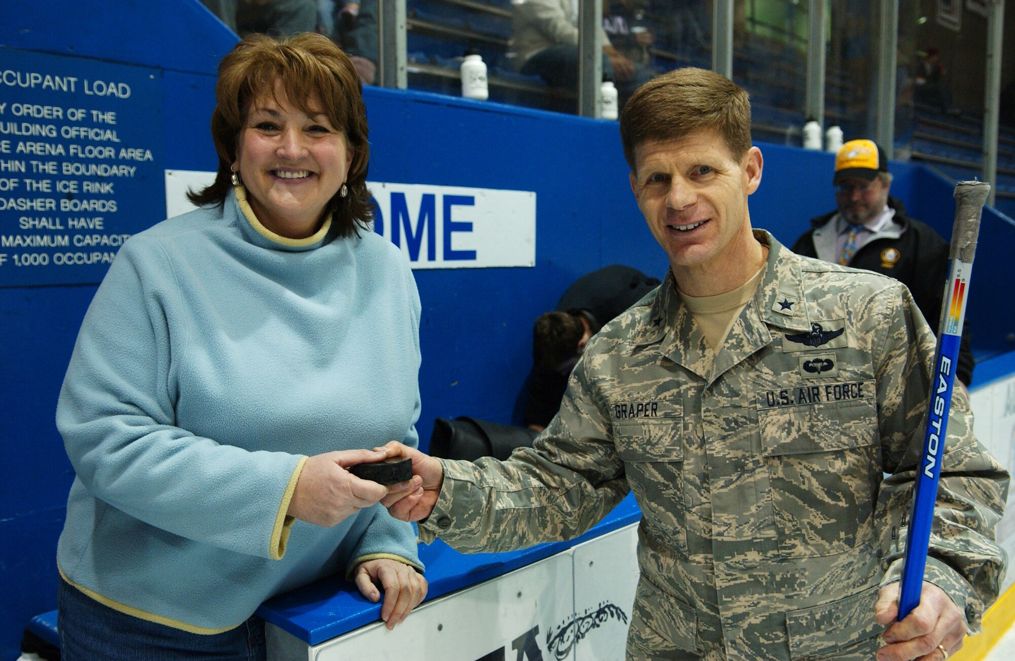 EIELSON AIR FORCE BASE, Alaska -  354th Fighter Wing Commander Brig. Gen. Mark Graper presents the honorary game puck to Fairbanks Mayor Mrs. Terry Strle Feb. 23 at the Big Dipper Ice Arena. The Eielson Icemen faced off against the Fort Wainwright Grizzlies in the 12th annual Commander's Cup, which was a free game for military families to enjoy. (U.S. Air Force Photo/Airman 1st Class Jonathan Snyder)