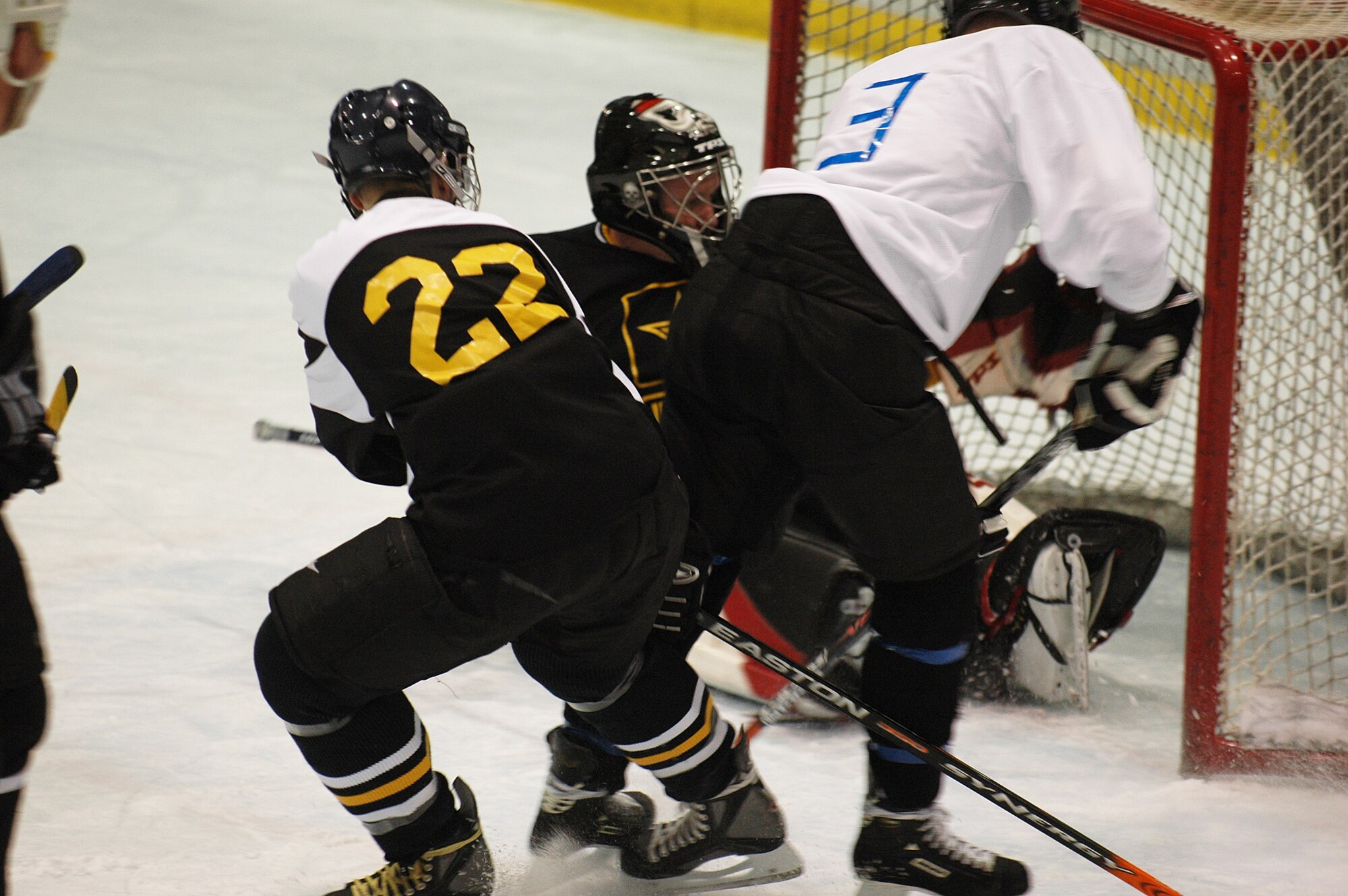 EIELSON AIR FORCE BASE, Alaska -- Scott McCreedy, No.3, shoots and scores on Mark Proffitt Feb. 23 at the Big Dipper Ice Arena. The Eielson Icemen faced off against the Fort Wainwright Grizzlies in the 12th annual Commander's Cup, which was a free game for military families to enjoy. McCreedy is assigned to the 353rd Combat Training Squadron. (U.S. Air Force Photo/Airman 1st Class Jonathan Snyder)