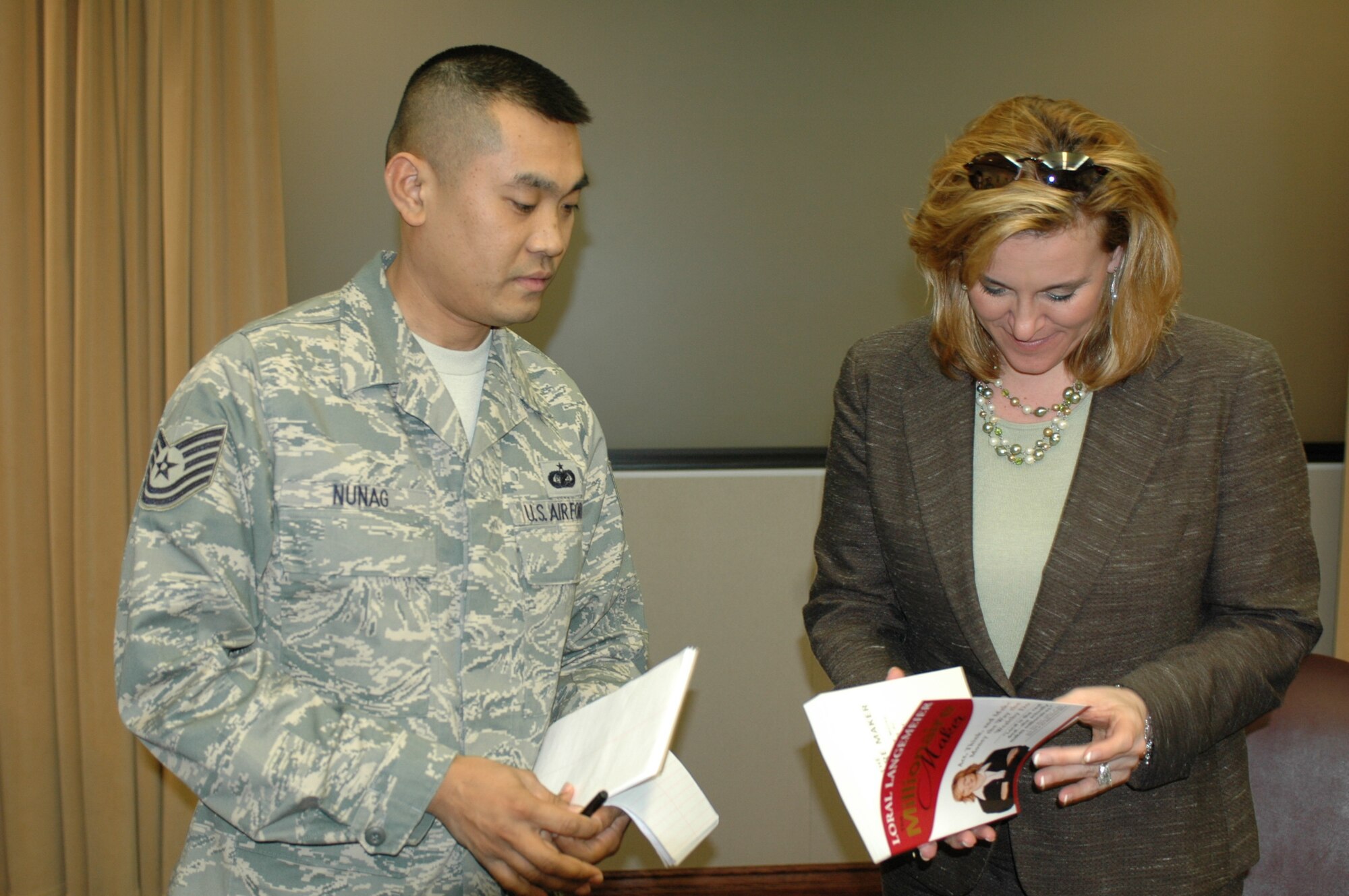 Tech. Sgt. Reny Nunag, 60th Air Mobility Wing, speaks with Loral Langemeier, author of the best seller; “The Millionaire Maker,” and founder and chief executive officer of Live Out Loud Feb. 25. Mrs. Langemaeier spoke to Travis Team members about using educational tools to build wealth as part of the kickoff of Travis’ second annual Military Saves campaign, “Operation Financial Freedom.” 