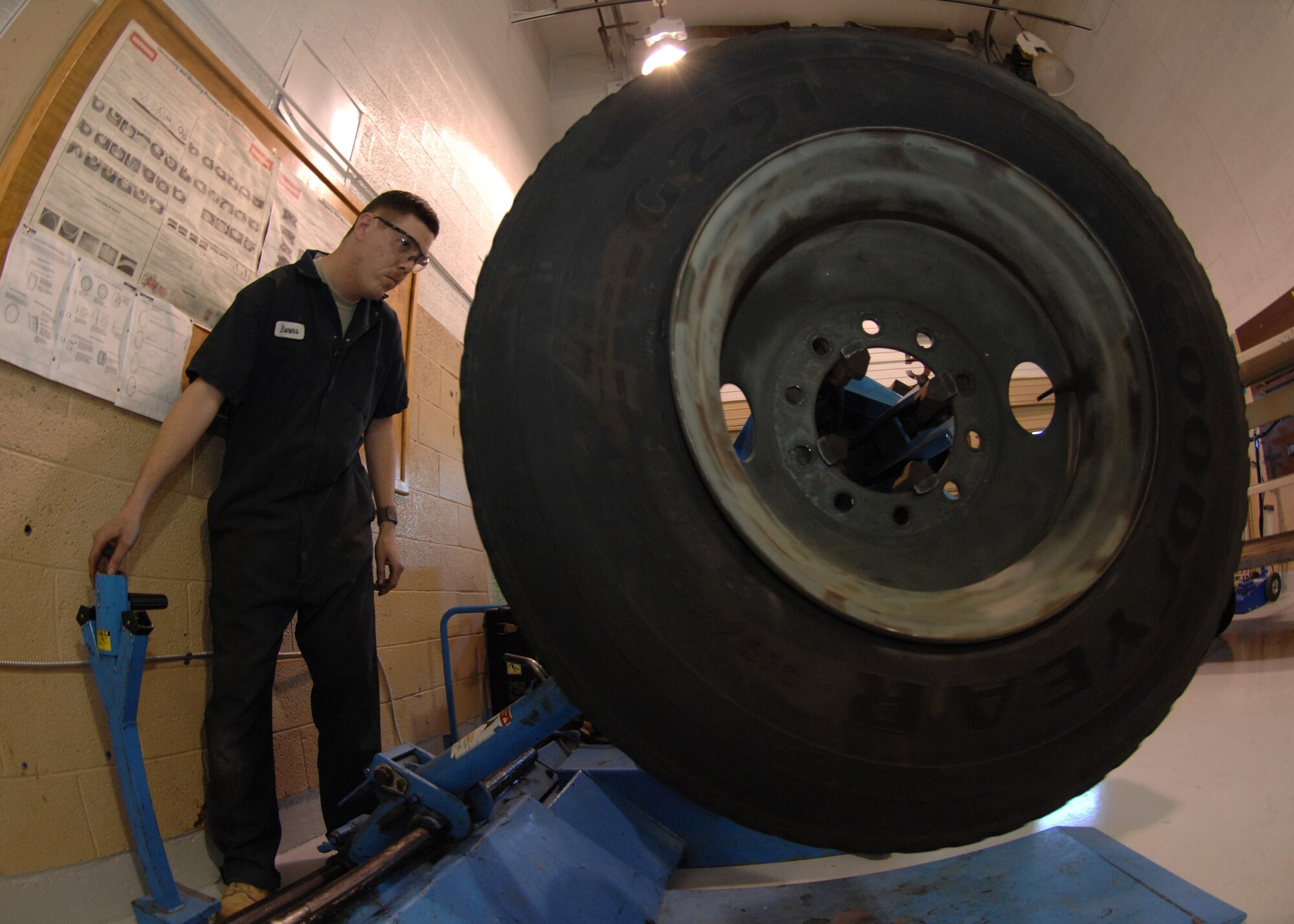 CANNON AIR FORCE BASE, N.M. - Staff Sgt. Matt Burns, 27th Special Operations Logistics Readiness Squadron, prepares to remove a tire from the rim to ensure that it meets safety requirements. Safety is a main priority for vehicle maintenance Airmen.(U.S. Air Force photo by Airman 1st Class Evelyn Chavez)