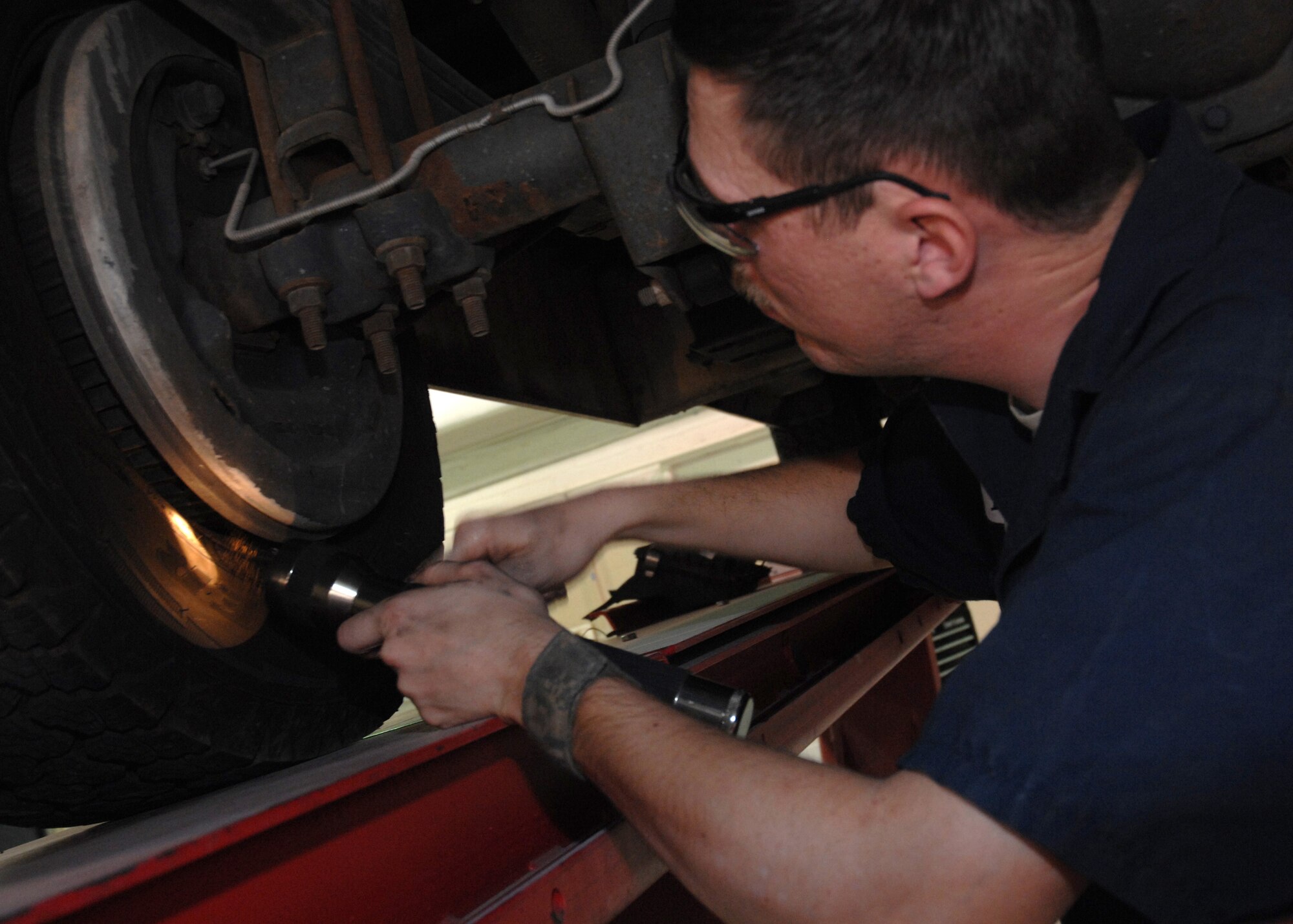 CANNON AIR FORCE BASE, N.M.-- Staff Sgt. Matt Burns,  27th Special Operations Logistics Readiness Squadron, ensures proper safety on tires of government vehicles. Safety is the main priority for vehicle maintenance Airmen.  (U.S. Air Force photo by Airman 1st Class Evelyn Chavez)