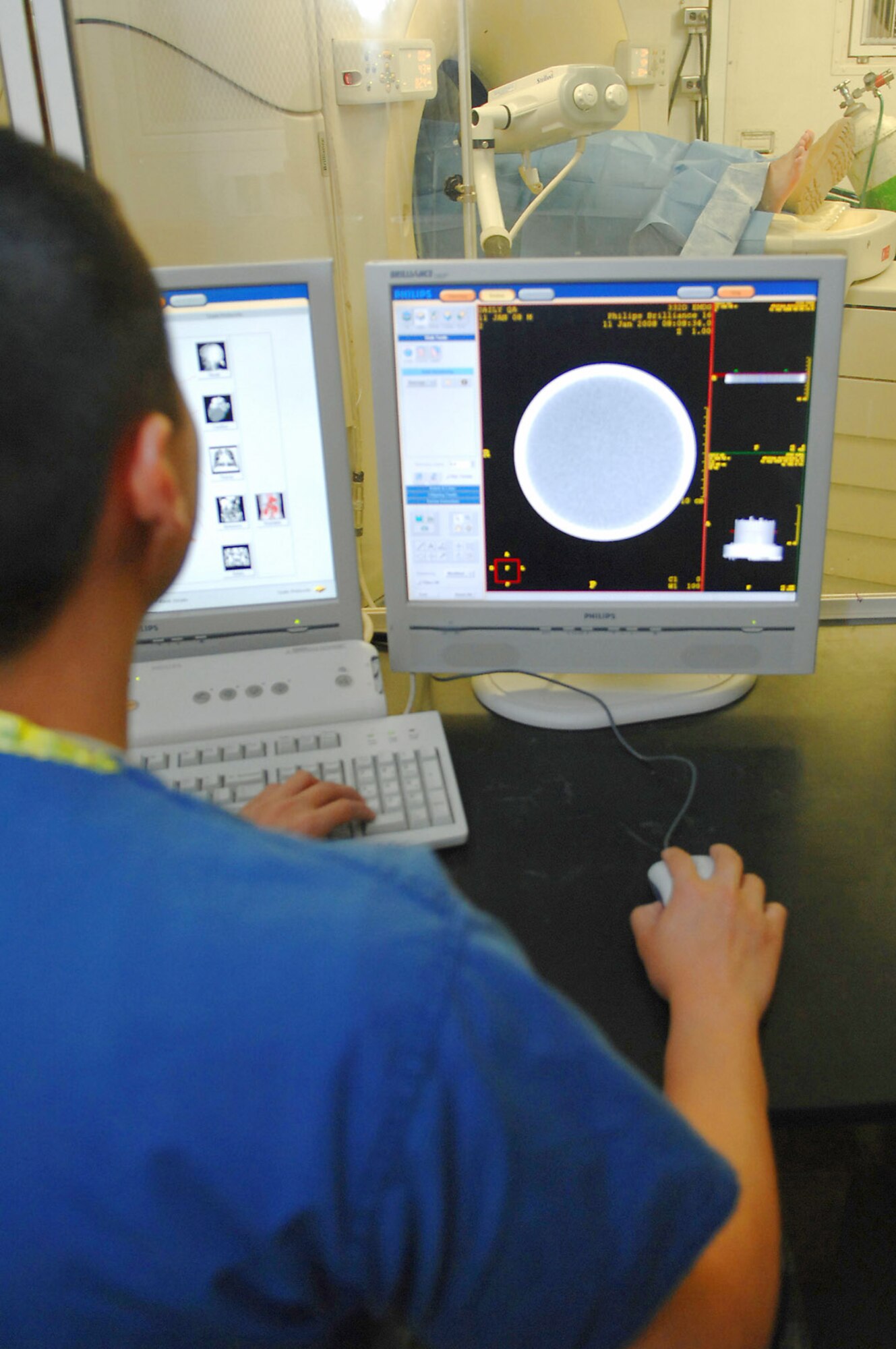 Senior Airman Jason Masiclat performs a CT scan on a trauma patient at the Air Force Theater Hospital Feb. 20 at Balad Air Base, Iraq. Airman Masiclat is a 332nd Expeditionary Medical Support Squadron radiology technologist deployed from Wright Patterson Air Force Base, Ohio. (U.S. Air Force photo/Senior Airman Julianne Showalter) 