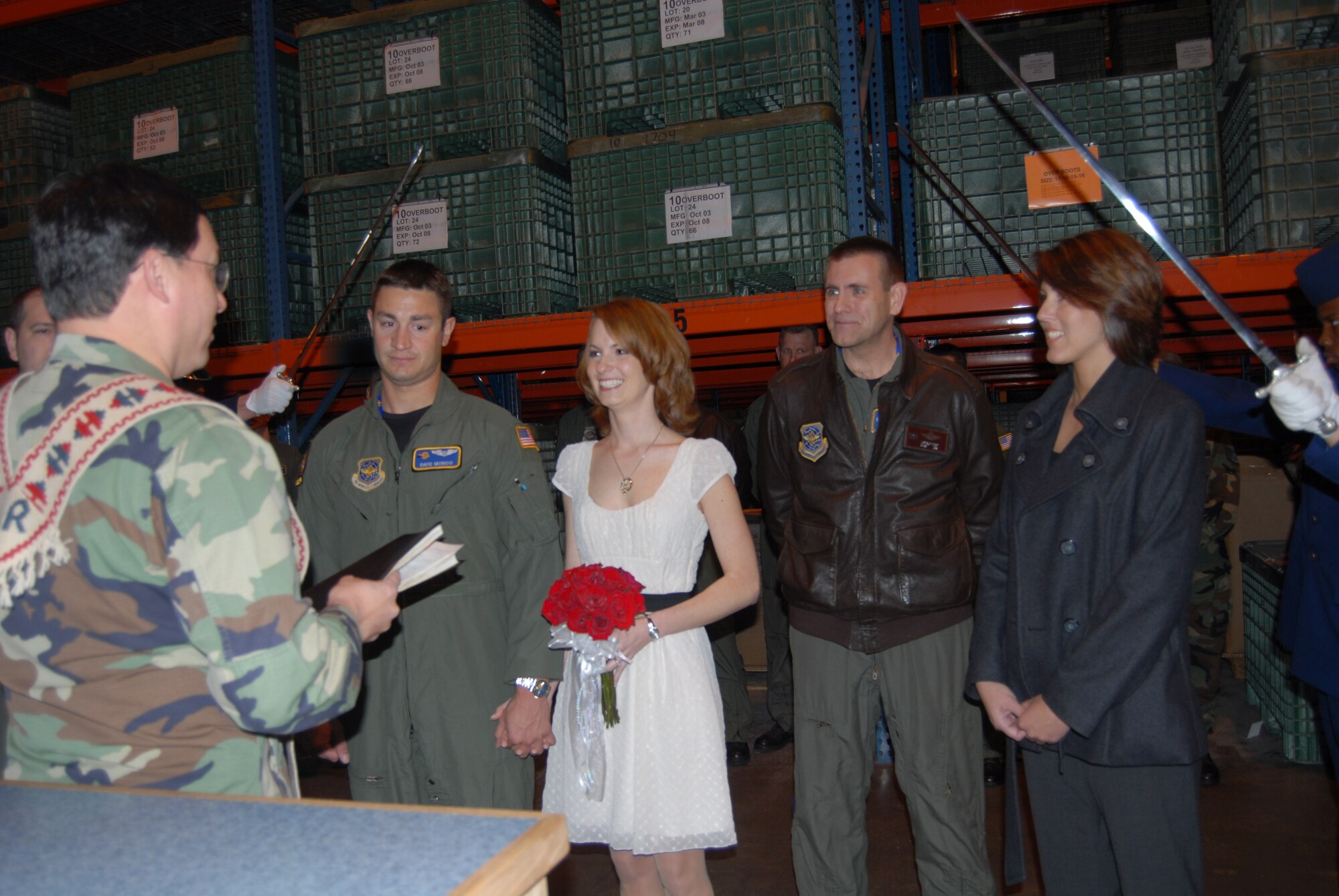 Chaplain (Maj.) Kenneth Reyes, 43rd Airlift Wing, performs a wedding ceremony for 1st Lt. David Monico, 2nd Airlift Squadron, and Monica Zelenuk during a redeployment inprocessing line at the 43rd Logistic Readiness Squadron's building 560 Feb. 25 with fellow Air Force members and friends in attendance. (U.S. Air Force Photo by Airman 1st Class Mindy Bloem)