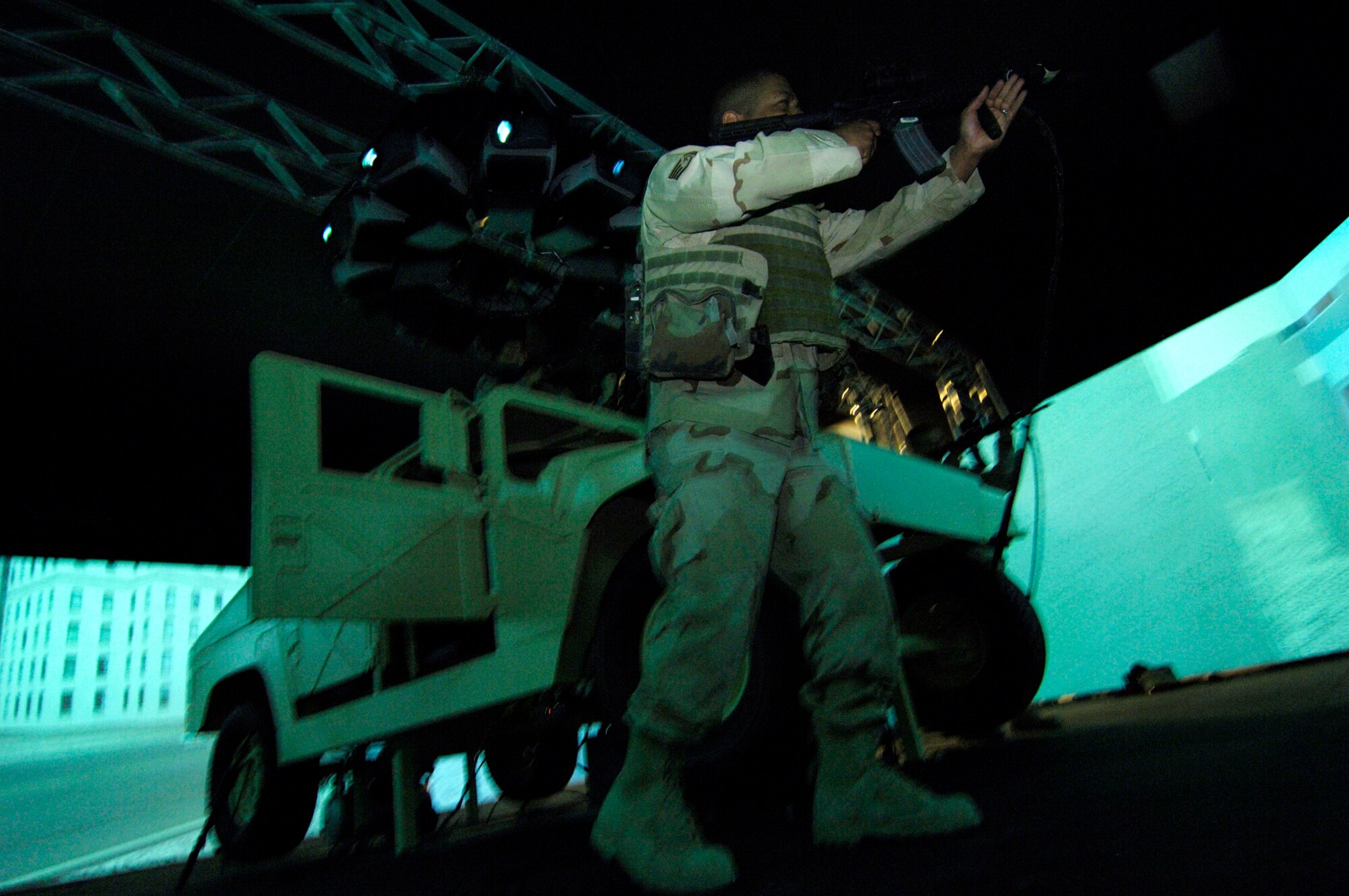 CREECH AIR FORCE BASE, Nev.—Staff Sgt. Bruce Thompson, 99th Ground Combat Training Squadron, integrated base defense instructor, “fires” an M-4 rifle at aggressing forces from a High Mobility Multipurpose Wheeled Vehicle simulator here Feb. 22. The simulator, a first of its kind, will be used to train Airmen in convoy operations and escalation of force tactics. (U.S. Air Force photo by Master Sgt. Kevin J. Gruenwald)