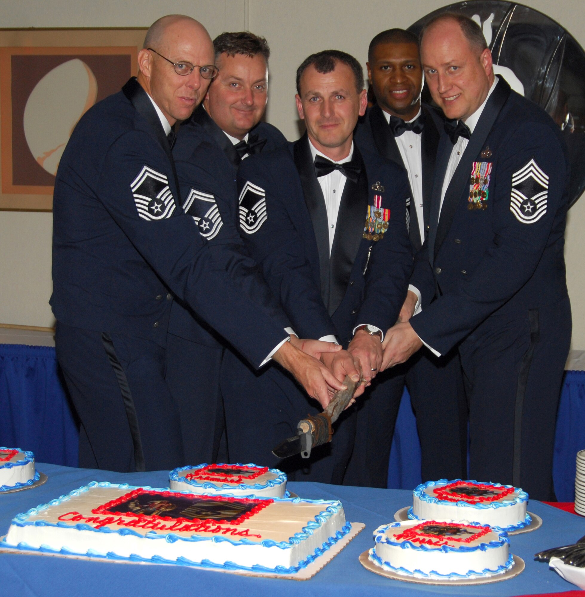 (From left to right) Senior Master Sgts. Richard Nordstrom, Donnie Morris and Leonard Krombel, and Chief Master Sgts. Leonard Howard and Christopher Saylor cut the ceremonial cake at the 2008 Chief Master Recognition Ceremony Feb. 22 at the Tyndall Community Activity Center Annex.  Inductees were selected for the top enlisted rank in the Air Force, an accomplishment achieved by only one percent of the total enlisted force.  (U.S. Air Force photo by Lisa Norman)