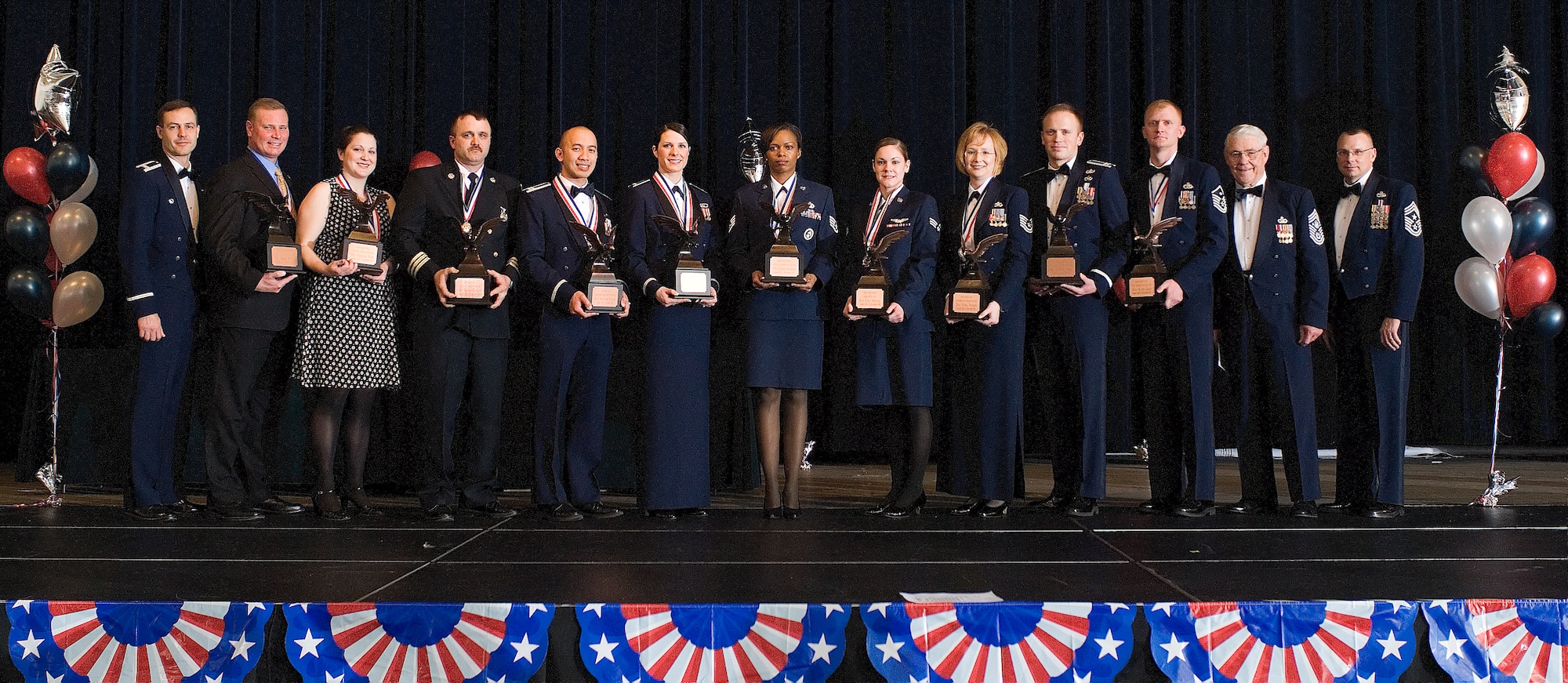 The annual award winners pose for a group photo with Col. Steve Harrison, 436th Airlift Wing commander, Retired Chief Master Sgt. Robert Gaylor, the fifth Chief Master Sgt. of the Air Force, and Chief Master Sgt. John Wood, 436th AW command chief, at the 436th Airlift Wing Annual Awards Banquet Feb. 20. (U.S. Air Force photo/ Roland Balik)