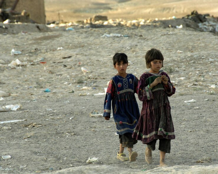 Nomadic Kuchi girls walk through an abandoned Soviet-era artillery range where they lived in January 2007 in Kabul, Afghanistan. International Security Assistance Force troops patrol the village. (U.S. Air Force photo/Master Sgt. Russell P. Petcoff) 