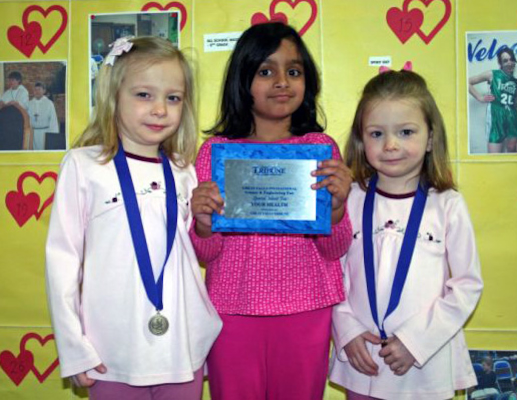 Little Warriors Emma and Mae Claire, 5, and their friend Gail, 5, (center) from Our Lady of Lourdes Catholic School, took first place medals in the kindergarten and first grade life science competition at the Great Falls Regional Science and Engineering Fair at the Mansfield Convention Center Feb. 9 . The trio also won the creativity award, a special merit award and the Great Falls Health Award for which they received plaques. (U.S. Air Force photo/ Suzanne Sabin)