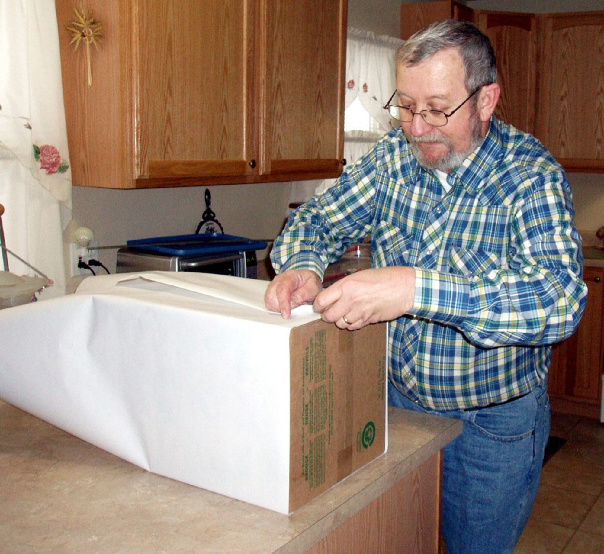 Denis Miller works on making a drop box for the Cell Phones for Soldiers program. On behalf of the Malmstrom Retirees Council, he is spearheading the cell phone donation project on base and in Great Falls. (Photo by Gloria Miller)