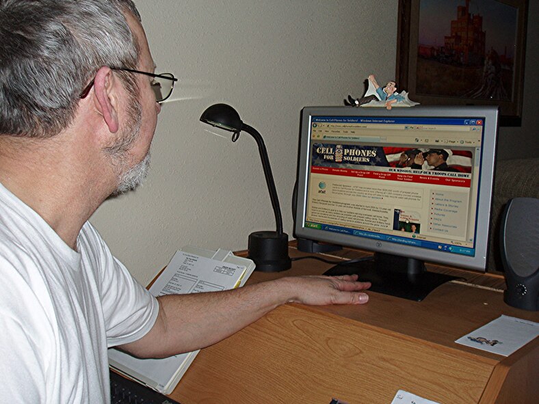 Denis Miller looks over the most recent information posted to the Cell Phones for Soldiers Web site. Representing the Retirees Council at Malmstrom, Mr. Miller took the steps on behalf of the group to be sponsors for this program at Malmstrom and in Great Falls. (Photo by Gloria Miller)