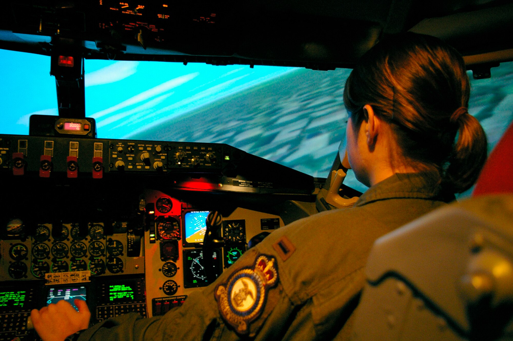 1st Lt. Jessica Bishop, 351st Air Refueling Squadron, simulates turning a KC-135 in one of the many worldwide landscape scenarios used in the simulator here at RAF Mildenhall, England. (U.S. Air Force photo by Karen Abeyasekere)