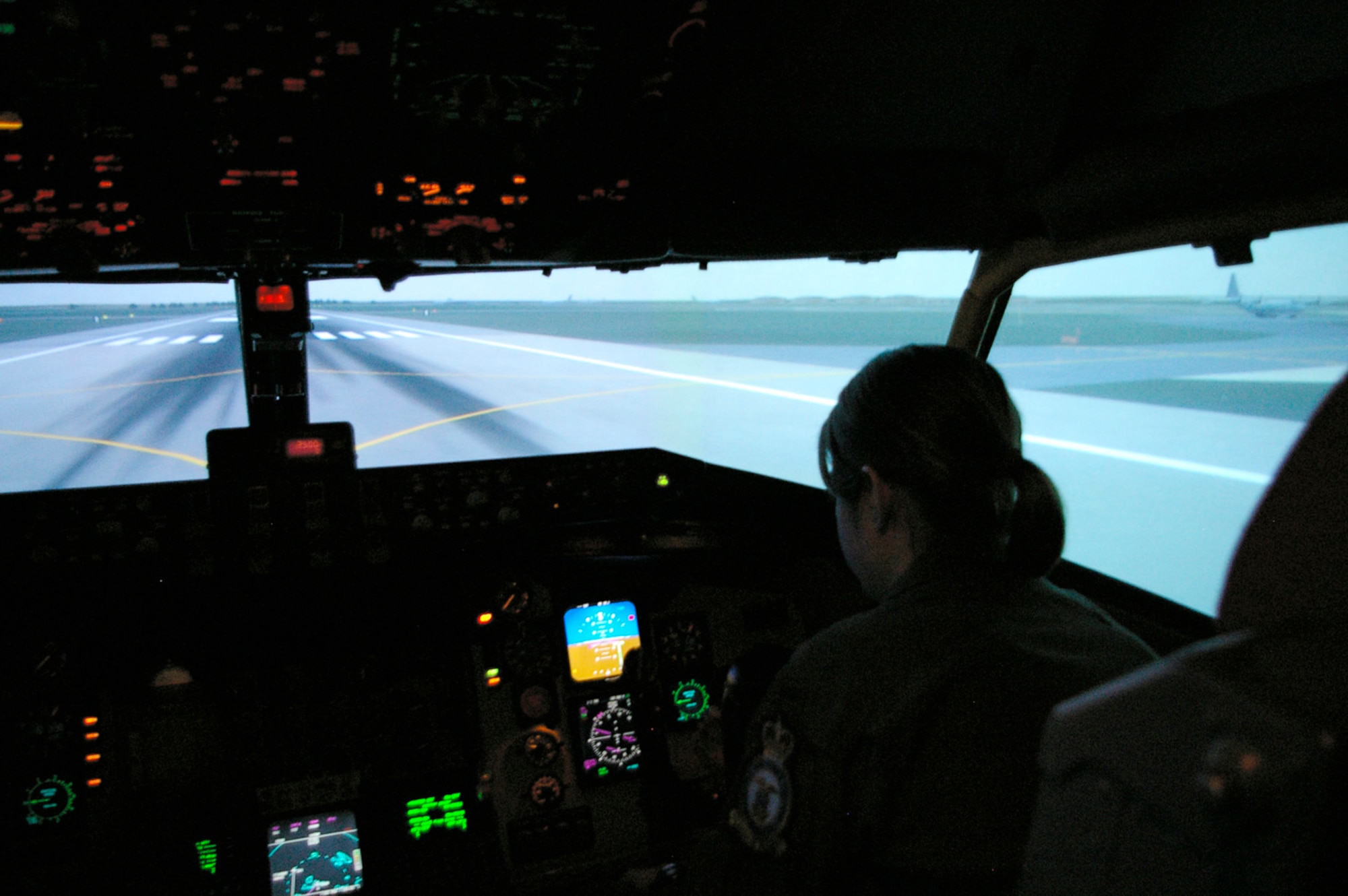 1st Lt. Jessica Bishop, 351st Air Refueling Squadron co-pilot, trains in the KC-135 simulator at RAF Mildenhall, England. The equipment can simulate just about any place in the world where there is a runway, and has about 30 custom databases, which means all the buildings and air traffic control towers will be in the right places. (U.S. Air Force photo by Karen Abeyasekere)