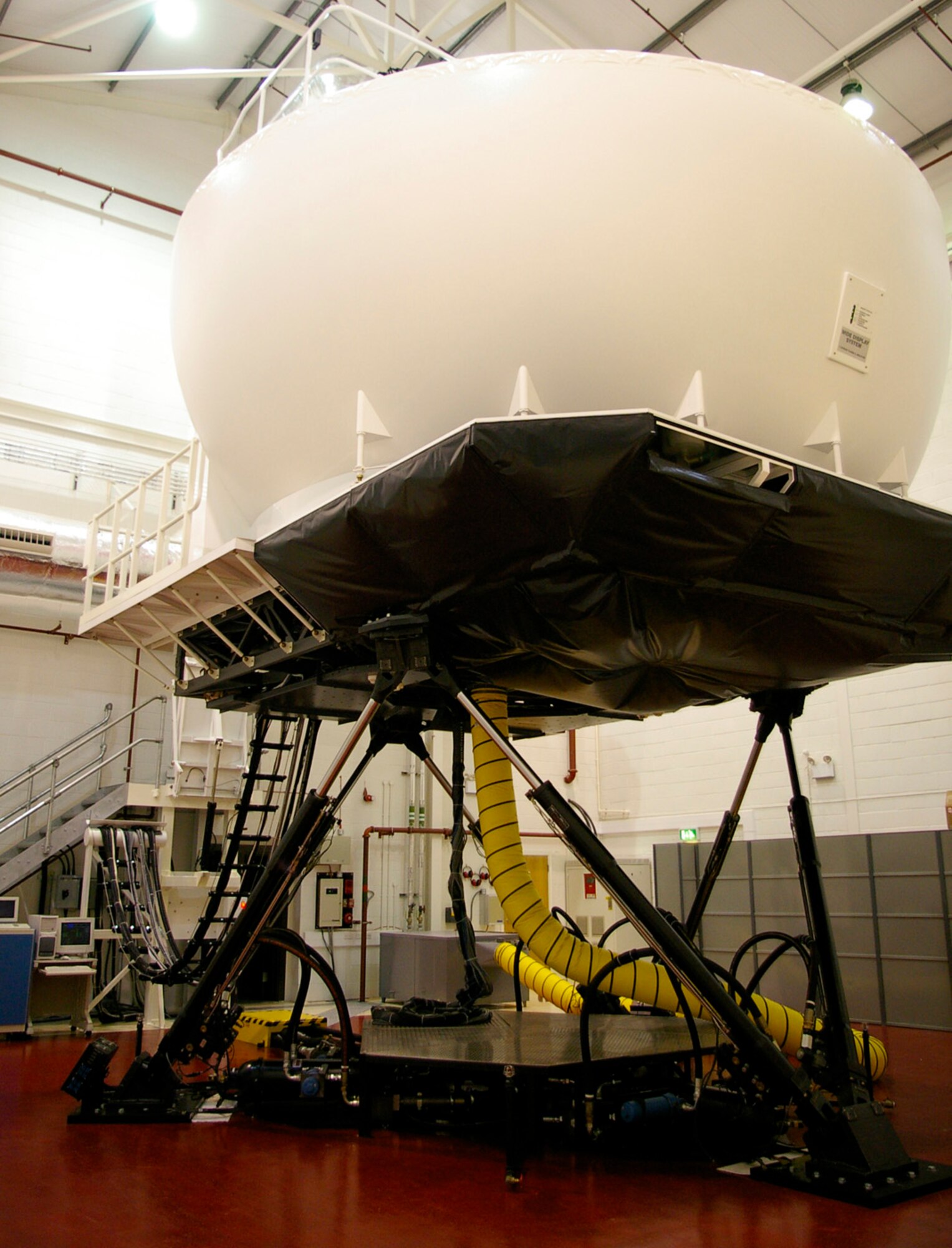 Team Mildenhall's multi-million dollar KC-135 Stratotanker simulator is run by contractors. The five personnel include instructors and technicians, responsible for training aircrews from the 351st Air Refueling Squadron. One hour of training costs around one-tenth of the amount to fly an actual jet. (U.S. Air Force photo by Karen Abeyasekere)