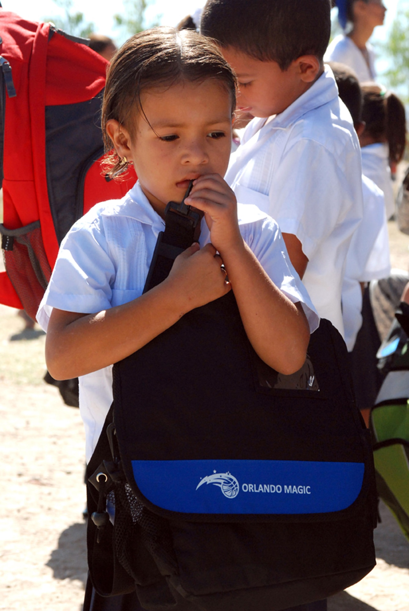 A girl at the Carlos Sanchez school in La Paz, Honduras, holds a backpack packed with school supplies given to her Feb. 21 by troops from Soto Cano Air Base, Honduras. Five representatives from the Give a Kid a Backpack Organization in Florida and 15 volunteers from Joint Task Force-Bravo distributed more than 700 backpacks packed with school supplies to children at five schools and two orphanages in the Comayagua and La Paz districts. (U.S. Air Force photo/Tech. Sgt John Asselin) 

