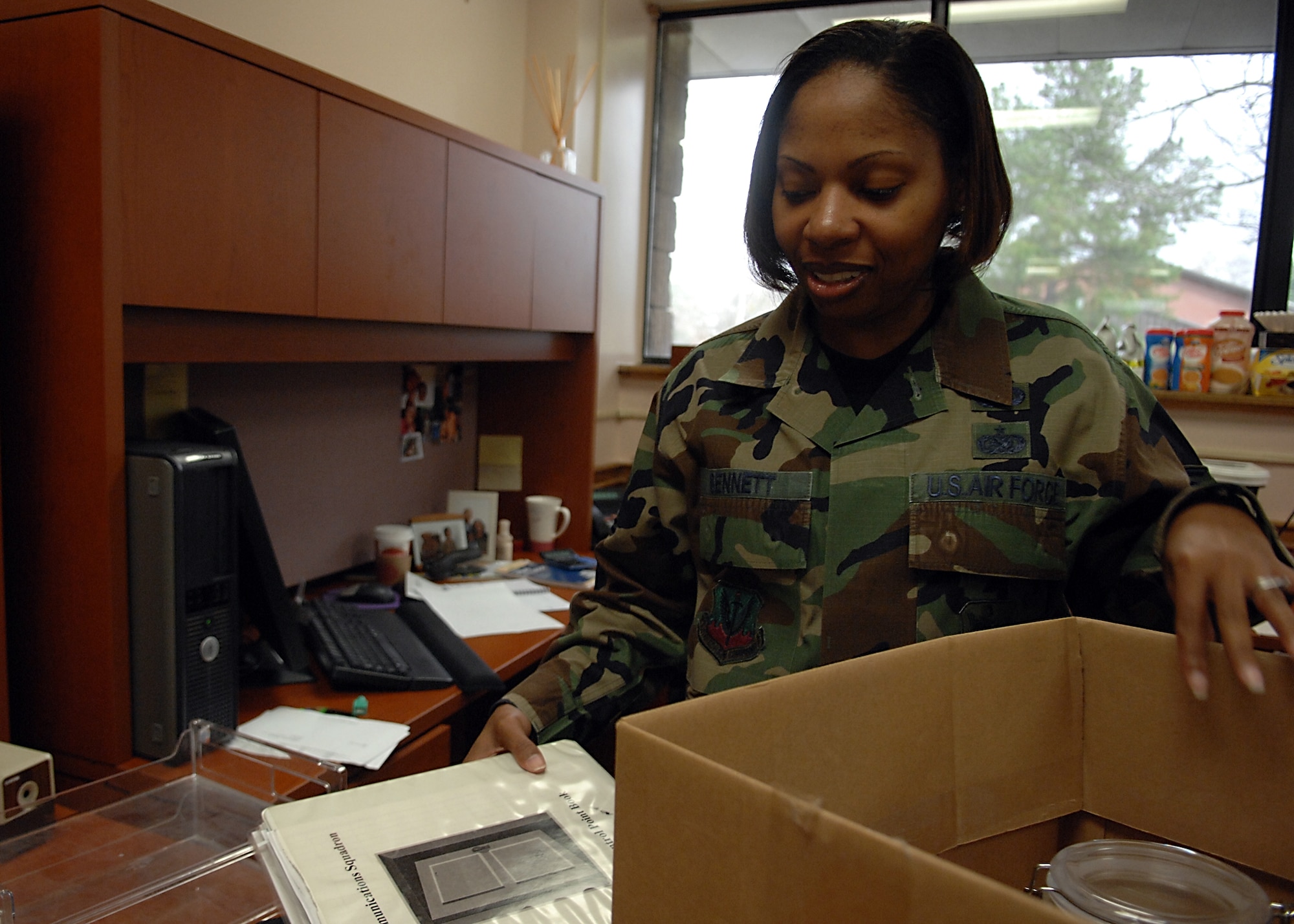MOODY AIR FORCE BASE, Ga. -- Tech. Sgt. Sherwon Bennett, 23rd Communication Squadron project manager,unpacks a box in her new office after she moved during the 23rd CS restructuring. The squadron is being formed into a two flight structure from a four flight structure. (U.S. Air Force photo by Airman 1st Class Brittany Barker)