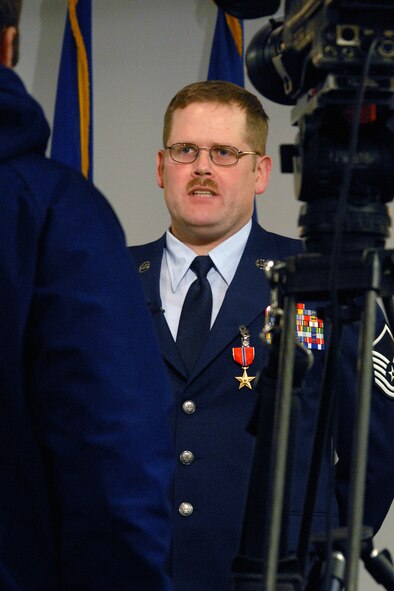 Master Sgt. Shayne Pederson answers questions for the media following an official ceremony where the Bronze Star Medal for Service  was presented to him for duties performed while deployed to Afghanistan. (U.S. Air Force photo/John Turner)