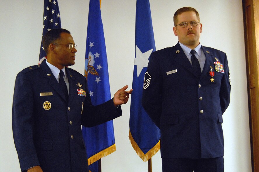 Brig. Gen, Everett Thomas talks about the character and passion of Master Sgt. Shayne Pederson following presentation of the Bronze Star Medal for Service Feb. 20. Sergeant Pederson earned the award while deployed to Afghanistan. General Thomas is the former 341st Space Wing commander and current vice commander for the U.S. Air Force Warfare Center at Nellis Air Force Base, Nev. (U.S. Air Force photo/John Turner)