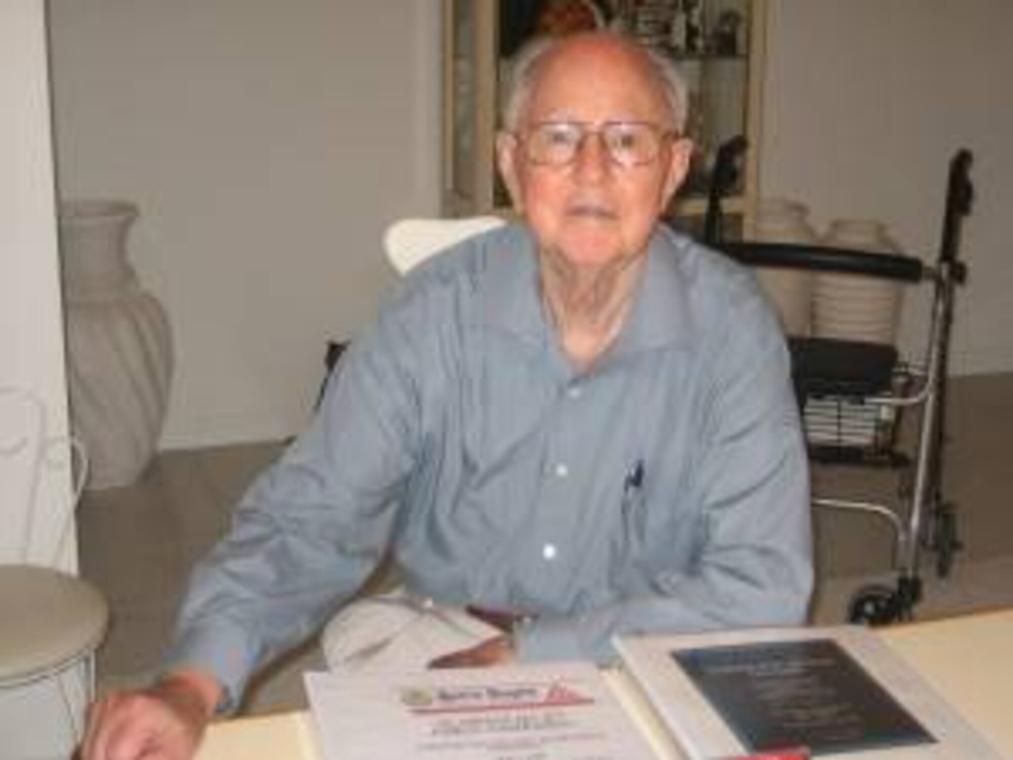 Retired Lt. Col Edgar Miller shown with the volumes containing the records of the  7.336 airmen who served with the 303rd Bomb Group (Heavy) at Molesworth during World War Two.  The records will officially be received into the records of the JIOCEUR Analytic Center on March 13th in a ceremony at the JAC.  (Photo Courtesy Citrus County Chronicle, Crystal River, Florida)