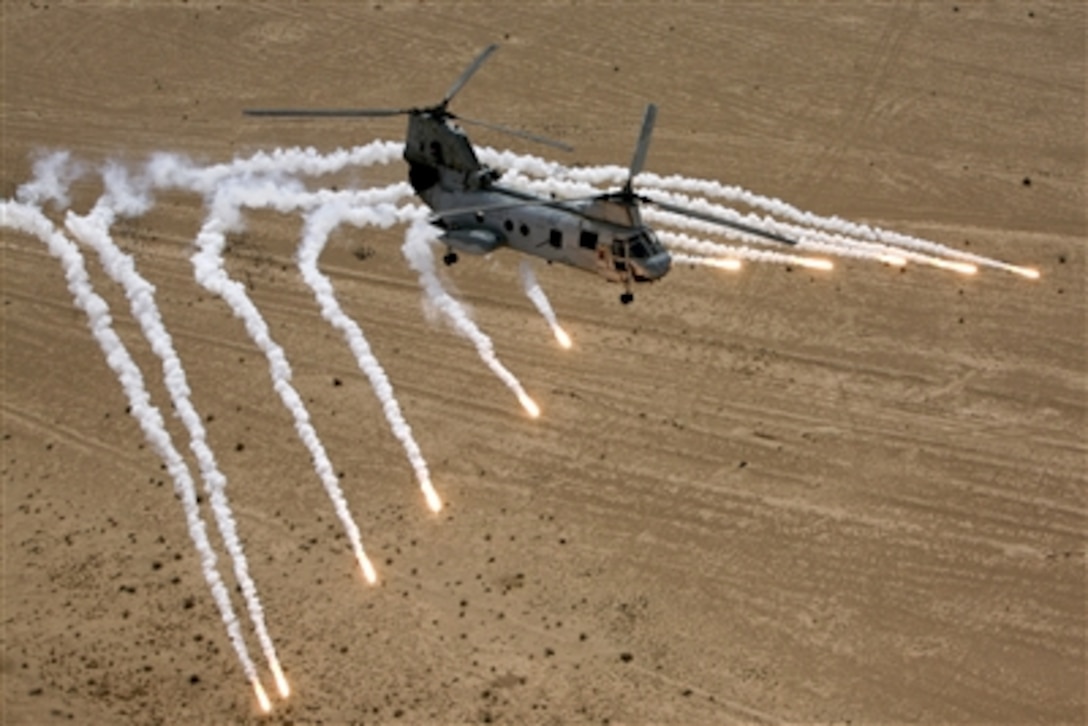 A U.S. Marine Corps CH-46 Sea Knight helicopter launches flares as it flies over the desert near Al Taqqadum, Iraq, on Feb. 24, 2008.  The Sea Knight is attached to Marine Medium Helicopter Squadron 268 and is deployed with Multi National Force - West in support of Operation Iraqi Freedom in the Al Anbar province of Iraq.  