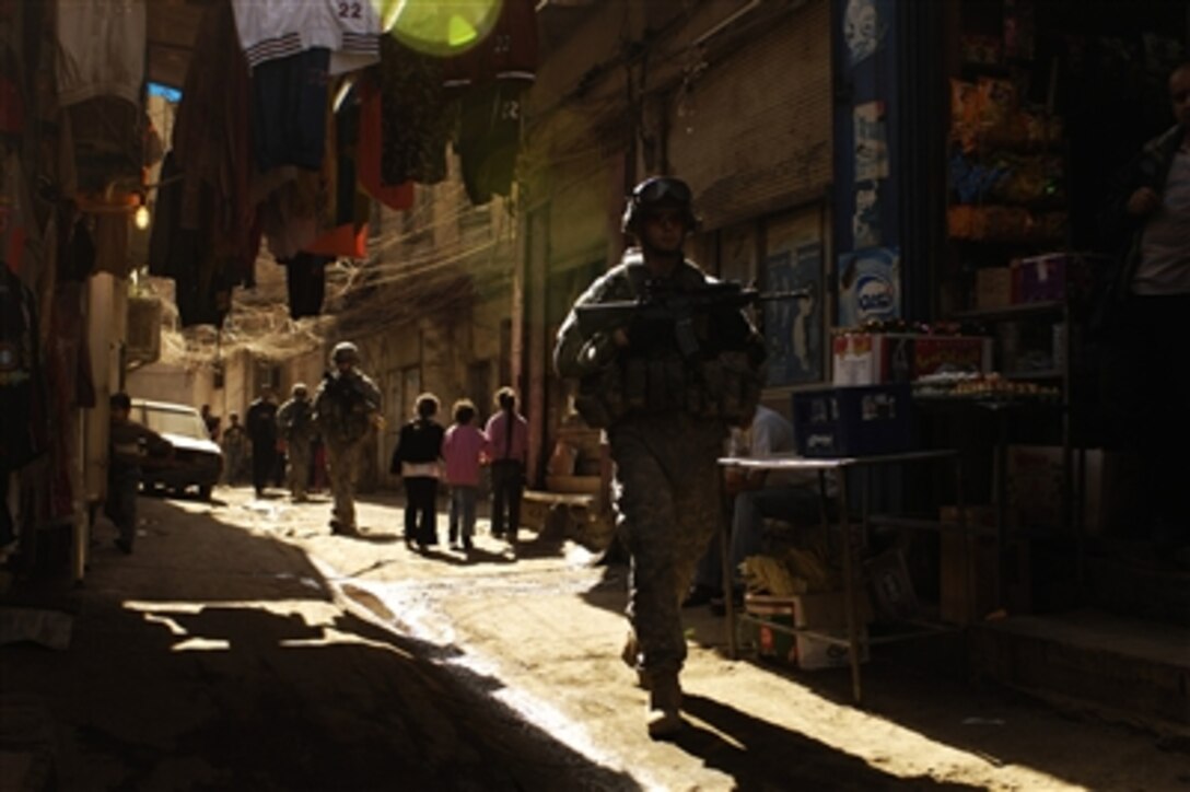 U.S. Army Sgt. Joseph Saladin leads the rear element as he patrols an alleyway in the Rusafa neighborhood of Baghdad, Iraq, on Feb. 17, 2008.  Saladin and his fellow soldiers are from the Armyís 3rd Platoon, Charlie Company, 1st Battalion, 504th Parachute Infantry Regiment.  