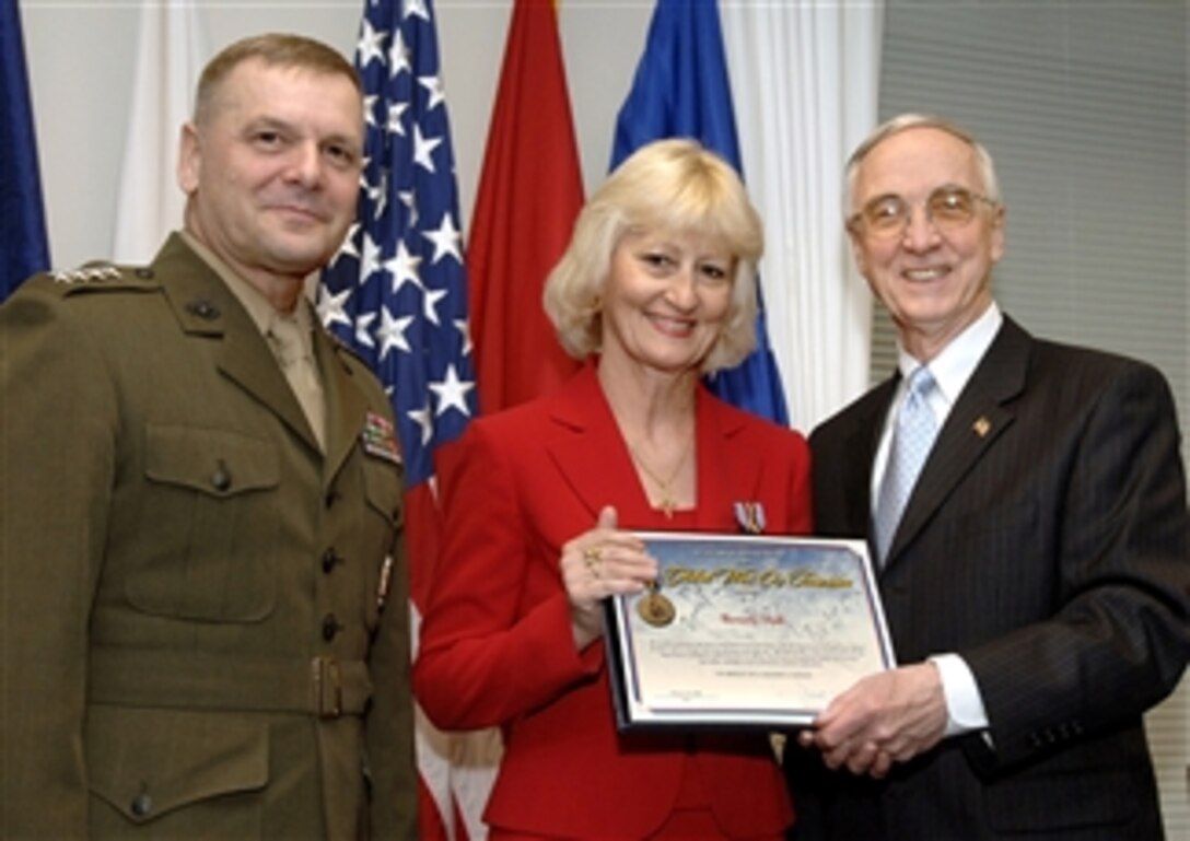 Deputy Secretary of Defense Gordon England, joined by Marine Gen. James E. Cartwright, vice chairman of the Joint Chiefs of Staff, present the first- ever awards of the Secretary of Defense Medal for the Global War on Terrorism during Pentagon ceremonies, Feb. 26, 2008. Here, Beverly Hall of the Defense Language Institute, accepts her award.  