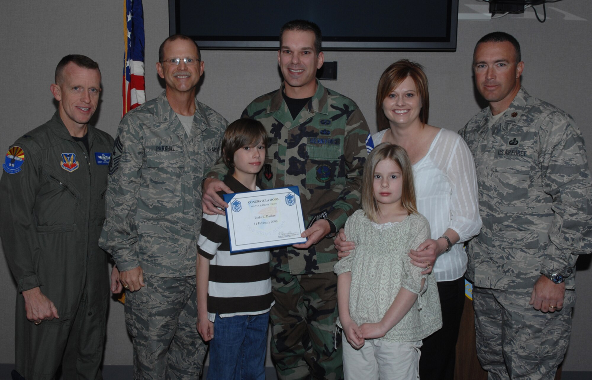 Master Sgt. Todd Barlow, accompanied by his family, pose for a photo with Colonel Kent Laughbaum, 355th Fighter Wing commander, Chief Master Sgt. James Parkhill, 355th Fighter Wing command chief, and Maj. James DeLong, 355th Contracting Squadron commander, Feb 11. Sergeant Barlow was STEP promoted from technical sergeant to master sergeant. (U.S. Air Force photo by Senior Airman Christina Kinsey)