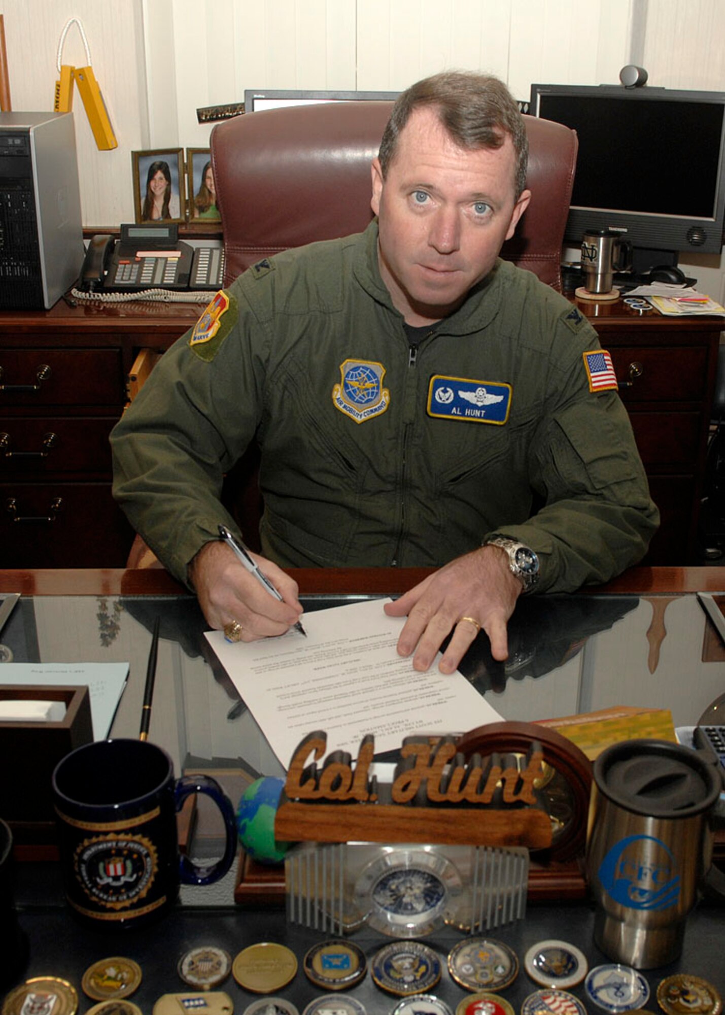 Col. Al Hunt, 375th Airlift Wing commander, signs the Military Saves Campaign for the Military Saves campaign which started Monday and runs through March 1. (U.S. Air Force Photo by Airman 1st Class Megan Gilliland)
