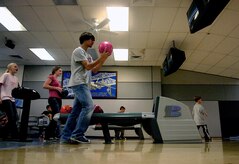 Austin Cannon lines up to bowl down a lane during the Worldwide Youth Bowling Tournament at Starlifter Lanes Saturday. Austin is the 17-year-old son of Patrick Cannon, a retired C-17 pilot. (U.S. Air Force photo/Senior Airman Nicholas Pilch)