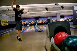 Benjamin Buckwalter, 12, son of Maj. Steven Buckwalter, celebrates after a strike during the Worldwide Youth Bowling Tournament at Starlifter Lanes Saturday. The bowling tournament which started this past Saturday was open to all children who could bowl. (U.S. Air Force photo/Senior Airman Nicholas Pilch)