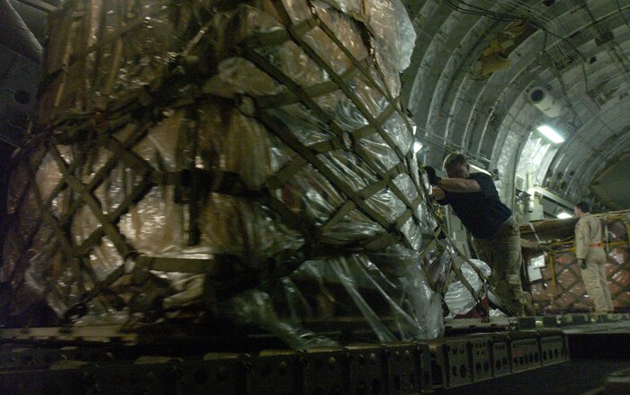 Airmen from the 818th Contingency Response Group, McGuire AFB, N.J., offload equipment from a C-17 Globemaster III from Charleston AFB at Chaklala AB, Pakistan, in support of earthquake relief efforts Oct. 17, 2005.  (U.S. Air Force photo/Tech. Sgt. Jeromy Cross)