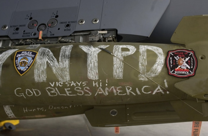 Arriving in theater only days before, F-15E Strike Eagles prepare to fly their first bombing missions in support of Operation Enduring Freedom into Afghanistan from a forward deployed base in Southwest Asia Oct.17, 2001.  The bombs, destined for targets in Afghanistan, are written on by Airmen from the squadron.  (U.S. Air Force photo/Master Sgt. Dave Nolan) 