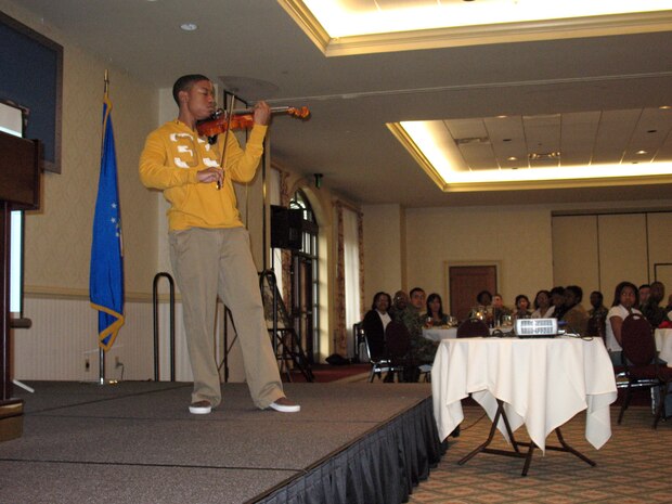 Daniel Davis performs with his violin as part of the African-American Heritage Committee's closing luncheon at the Charleston Club Tuesday. Mr. Davis is the son of Chief Master Sgt. Reginald Davis and has performed at various local events, including the opening act for Tops in Blue. (U.S. Air Force photo/Staff Sgt. Jennifer Arredondo)