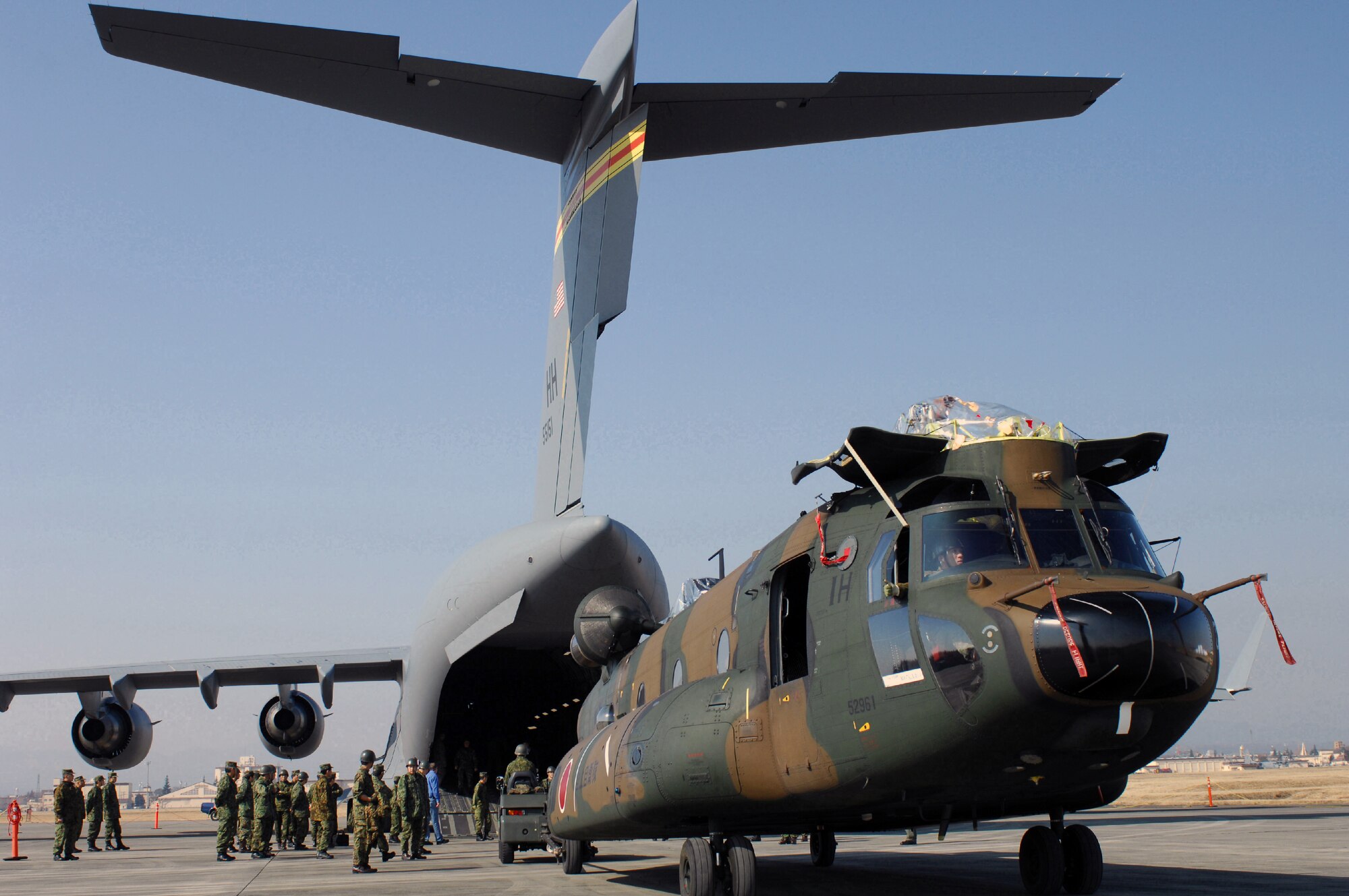 A Japan Ground Self Defense Force CH-47J Chinook is loaded onto a C-17 Globemaster III cargo plane Feb. 23 at Yokota Air Base, Japan. The demonstration was conducted the during the Pacific Global Air Mobility Seminar held Feb. 22 and 23. The CH-47J is assigned to the 1st Helicopter Brigade at JGSDF Camp Kisarazu in Kisarazu City, Chiba Prefecture, and the C-17 is assigned to the 535th Airlift Squadron at Hickam Air Force Base, Hawaii. (U.S. Air Force photo/Osakabe Yasuo) 
