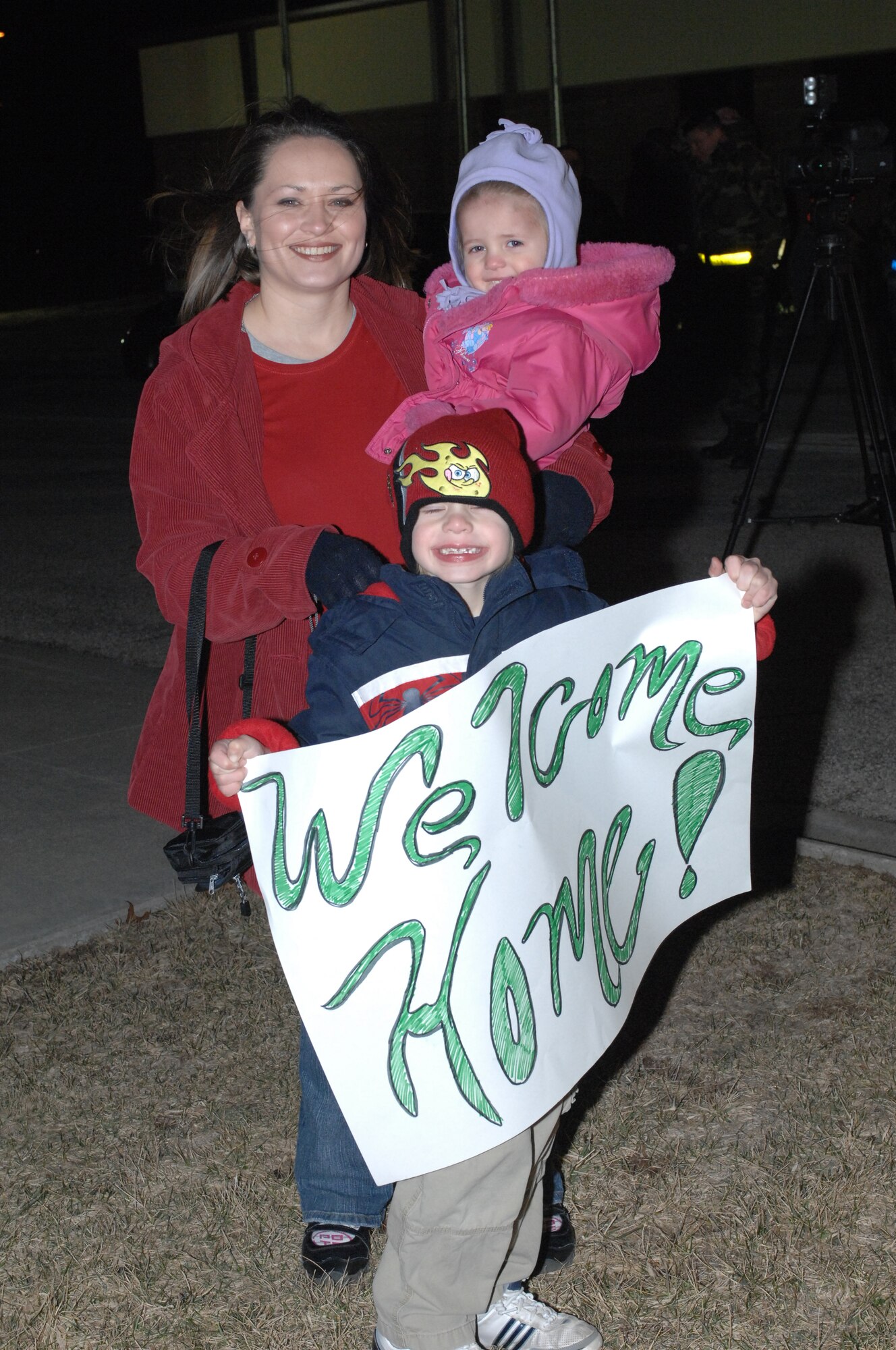 WHITEMAN AIR FORCE BASE, Mo. – Misty Halvorsen, wife of Tech. Sgt. Todd Halvorsen, 509th Maintenance Squadron, and her children, Leyten and Lyvia get ready to welcome Sergeant Halvorsen home from a deployment to Andersen Air Force Base, Guam Feb. 26. (U.S. Air Force photo/Tech. Sgt. Samuel A. Park) 