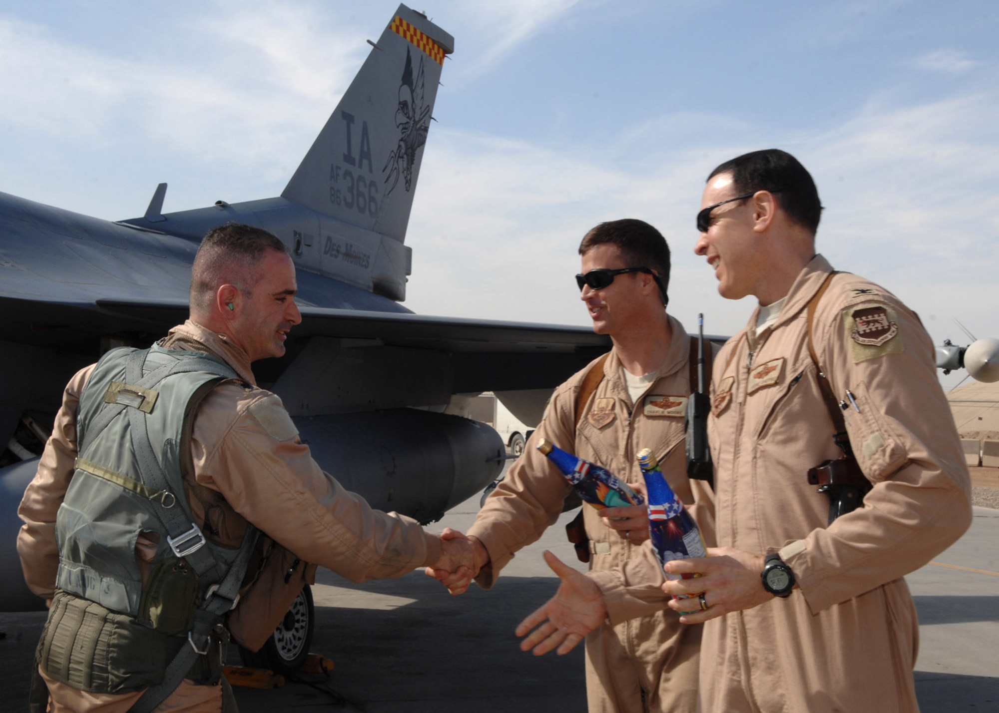 Lt. Col. George Uribe is greeted and congratulated by Col. Steven Shepro and Col. Charles Moore after completing 1,000 combat flying hours as an F-16 Fighting Falcon pilot Feb. 17 at Balad Air Base, Iraq. Colonel Uribe is a 332nd Expeditionary Operations Group fighter pilot and deployed from Tyndall Air Force Base, Fla. Colonel Shepro is the 332nd Air Expeditionary Wing vice commander, and Colonel Moore is the 332nd Expeditionary Operations Group commander. (U.S. Air Force photo/Senior Airman Julianne Showalter) 
