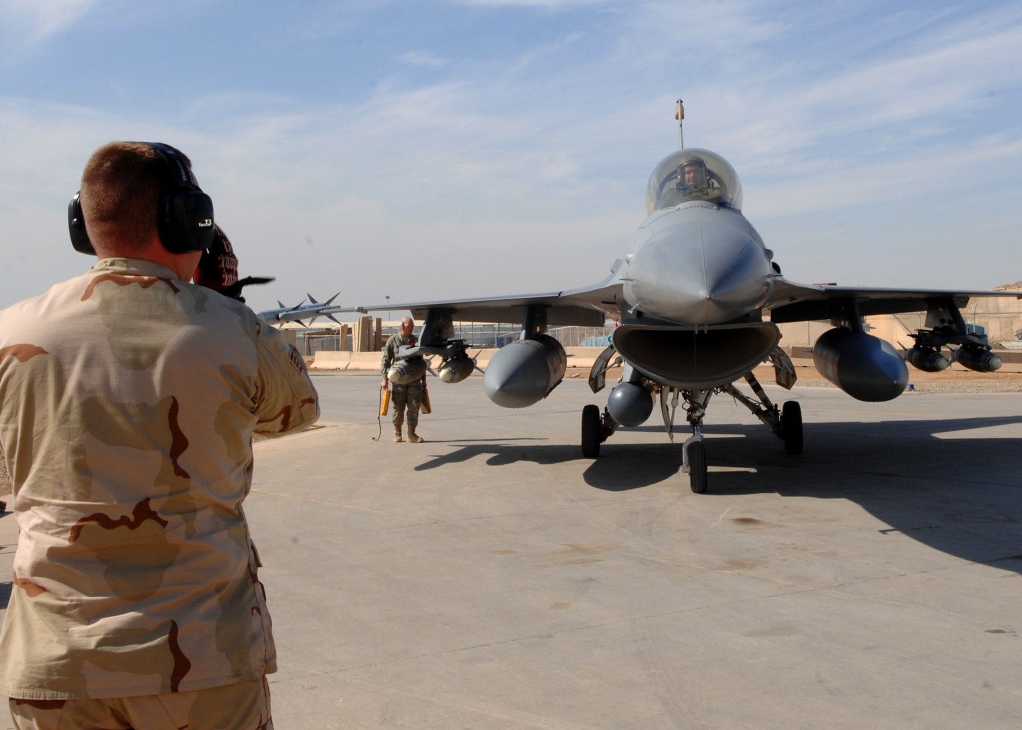 Lt. Col. George Uribe taxies into a hardened aircraft shelter after completing 1,000 combat flying hours as an F-16 Fighting Falcon pilot Feb. 17 at .Balad Air Base, Iraq. Colonel Uribe is a 332nd Expeditionary Operations Group fighter pilot and deployed from Tyndall Air Force Base, Fla. (U.S. Air Force photo/Senior Airman Julianne Showalter) 
