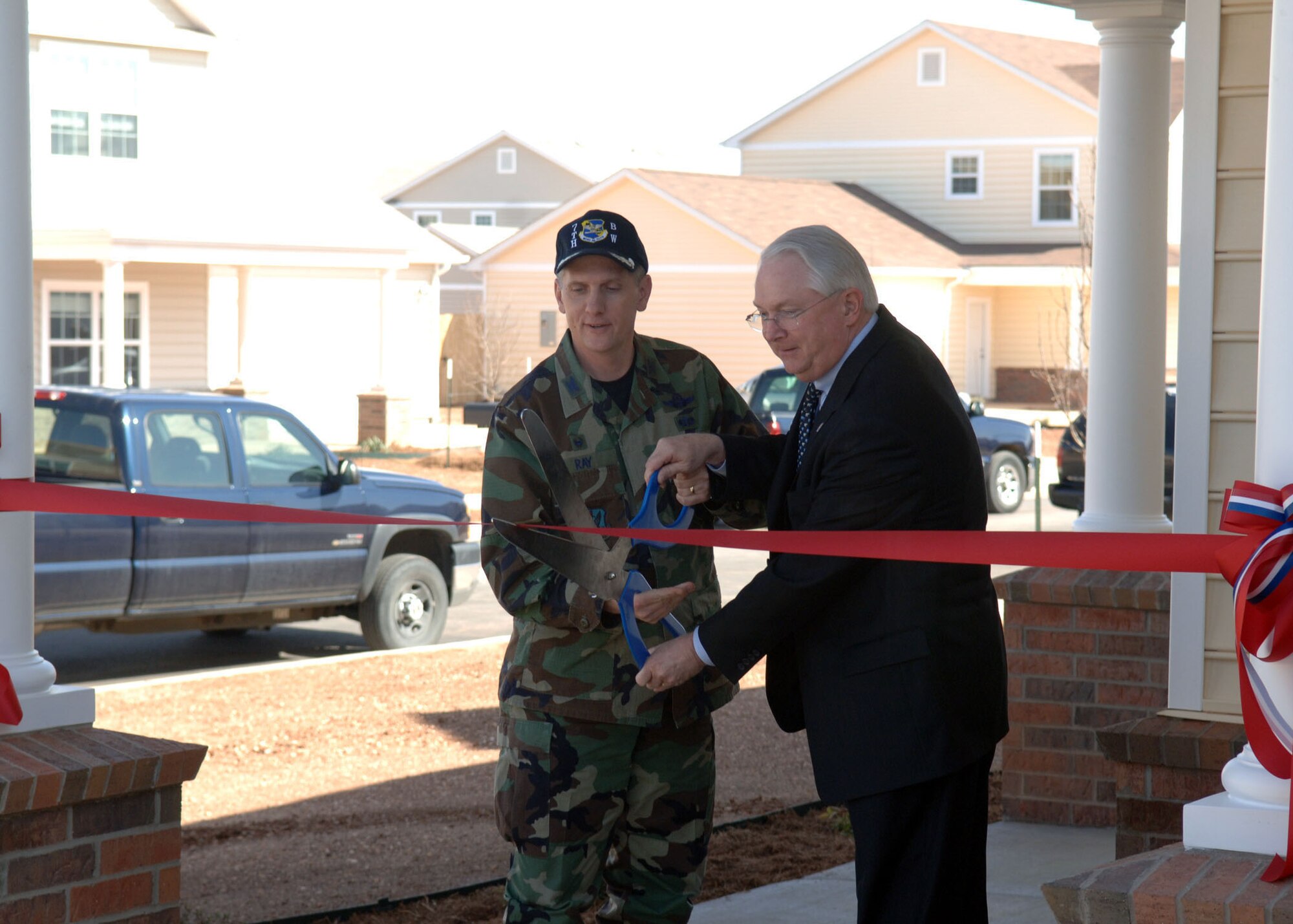 DYESS AFB, Tx-- Colonel Timothy Ray and Congressman Randy Neugebauer cut the ribbon to the new base housing area on Feb. 22. The pictured was given to Airman 1st Class Xavier Crox's family.  (U.S. Air Force Photo by Airman 1st Class Micheal Breaux)