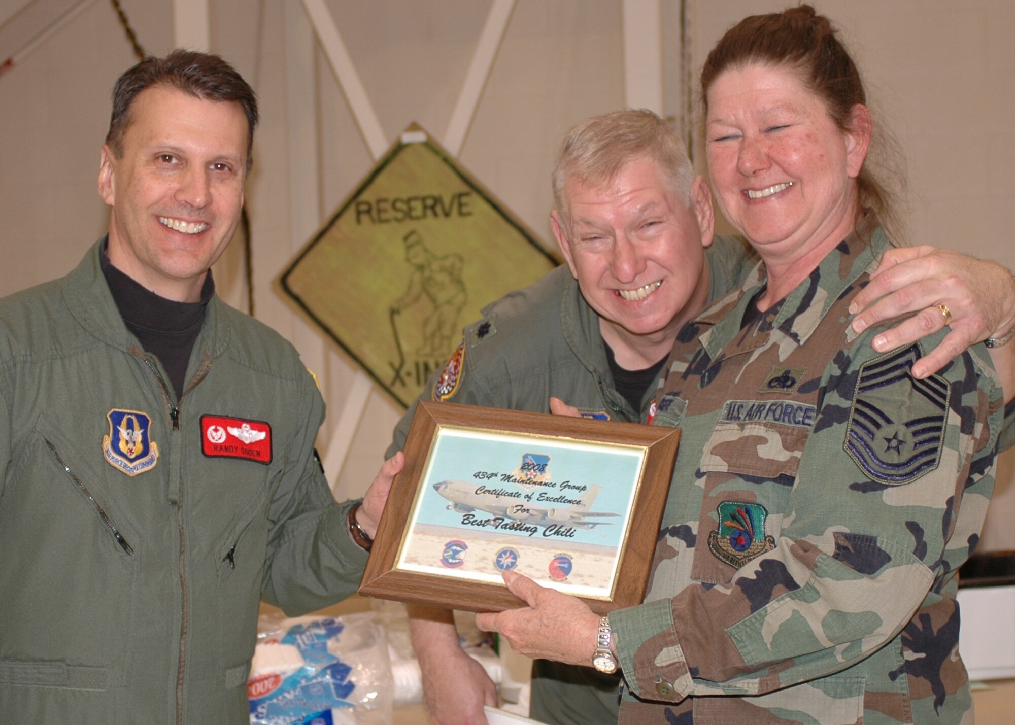 GRISSOM AIR RESERVE BASE, Ind., -- From left, Col. Randall Ogden, 434th Operations Group commander, and Lt. Col. Don Windt, 434th Operations Support Squadron commander, present Chief Master Sgt. Diana Rogers, 434th Maintenance Group superintendent, a certificate for the best tasting chili during the 434th Maintenance Group's Chili Cook-off. (U.S. Air Force photo/Tech. Sgt. Doug Hays)