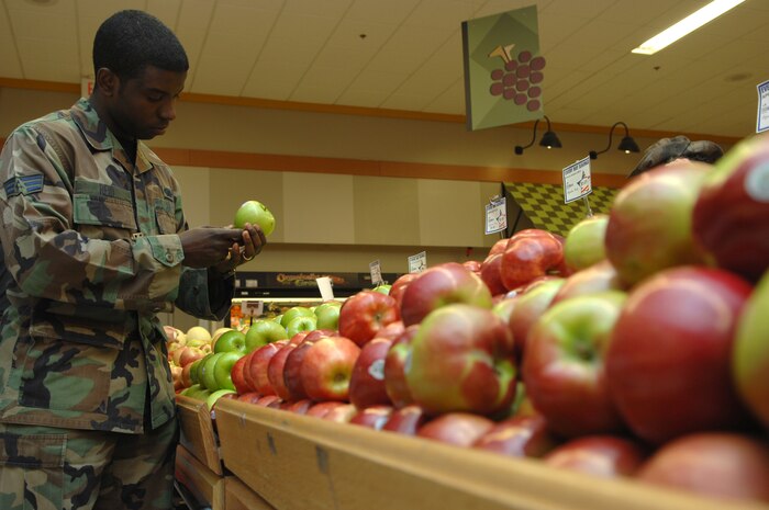 NELLIS AIR FORCE BASE, Nev.—Senior Airman Larry Reid, 99th Air Base Wing, photographer, chooses a healthy alternative snack from the produce section at the commissary here Feb. 26, as part of his continuing efforts to stay fit. (U.S. Air Force photo by Senior Airman Nadine Y. Barclay)