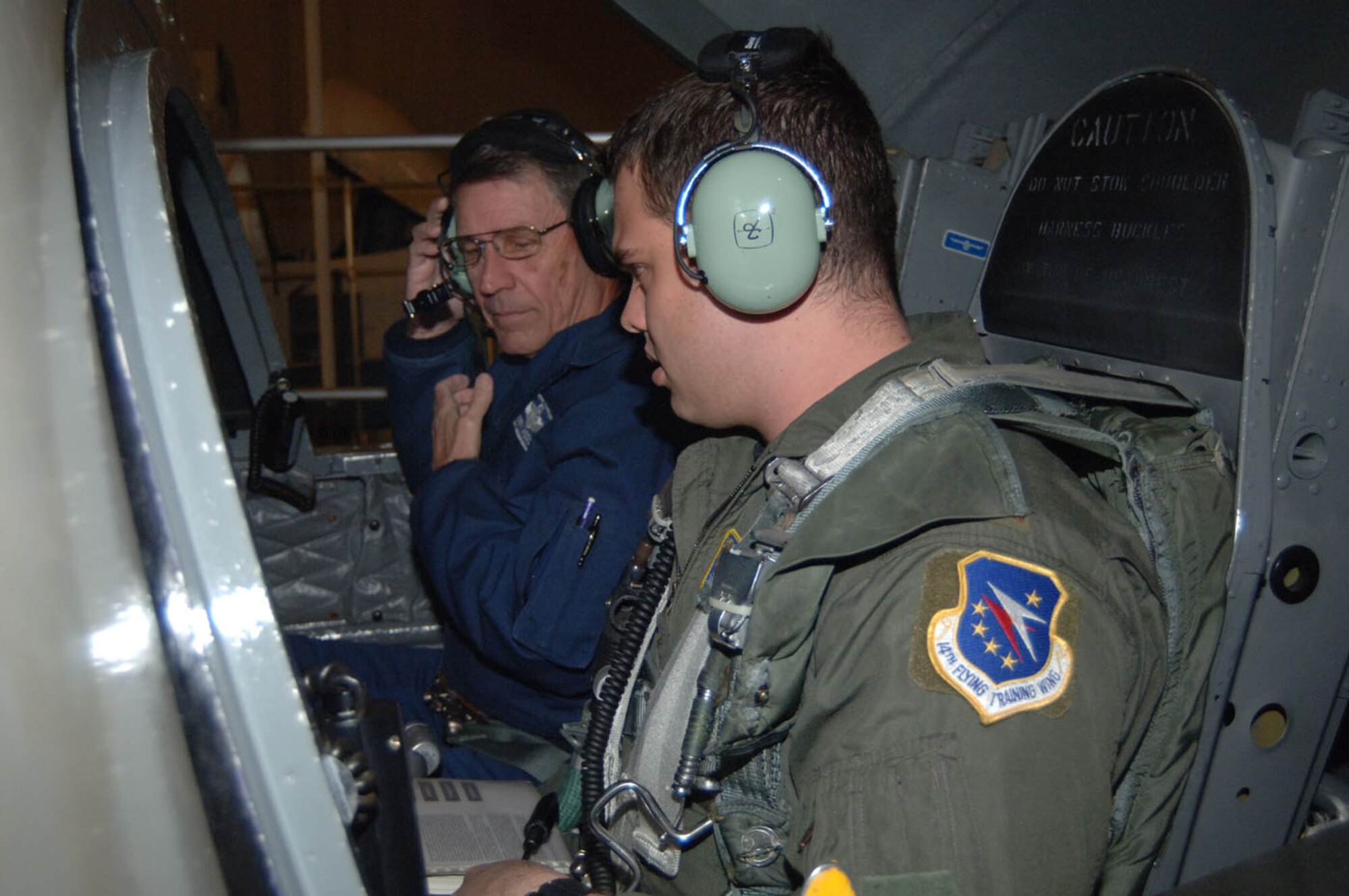 Second Lt. Zachary Walrond, SUPT class 08-15, and Lear Siegler Services, Inc., instructor Jerry Hodson, prepare for the last T-37 student syllabus simulator sortie at Columbus AFB Tuesday. The first T-37 simulators were introduced to Columbus AFB in 1979. The wing-wide T-37 retirement ceremony will be held April 3. (U.S. Air Force photo by Airman 1st Class Danielle Hill)