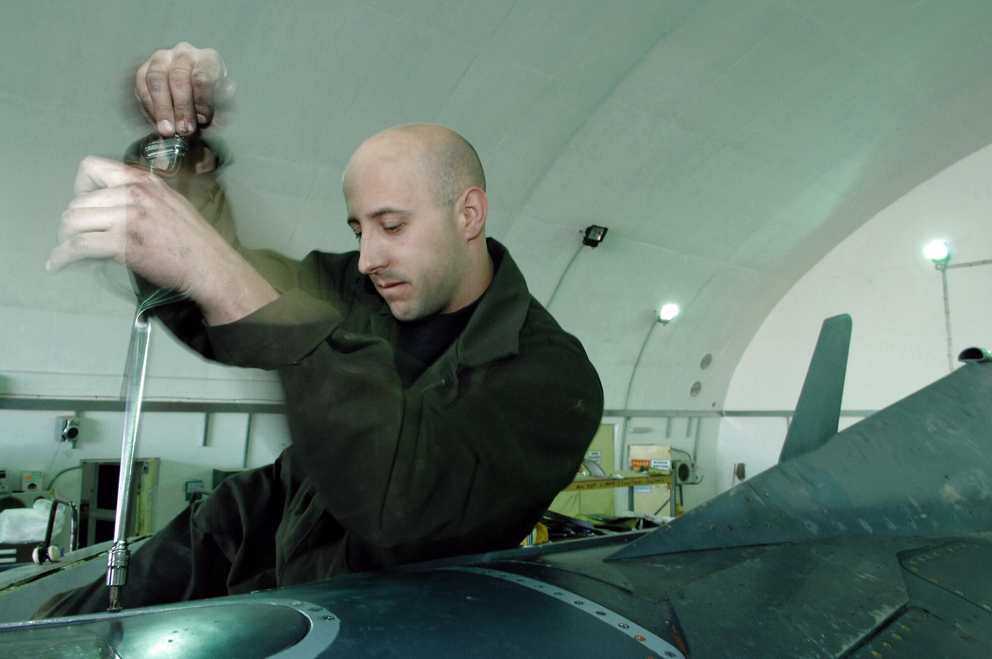 Tech. Sgt. Robert Fredenberg reinstalls the refueling panel after fixing a small dent Feb. 22 at Balad Air Base, Iraq. The dent was caused during an in-flight refueling. During a 300-flight hour inspection all panels are removed and inspected for cracks and dents, all pieces are repaired, if needed, before reinstallation. Sergeant Fredenberg is a 332nd Expeditionary Maintenance Squadron crew chief deployed from the Wisconsin National Guard. (U.S. Air Force photo/Senior Airman Julianne Showalter)
