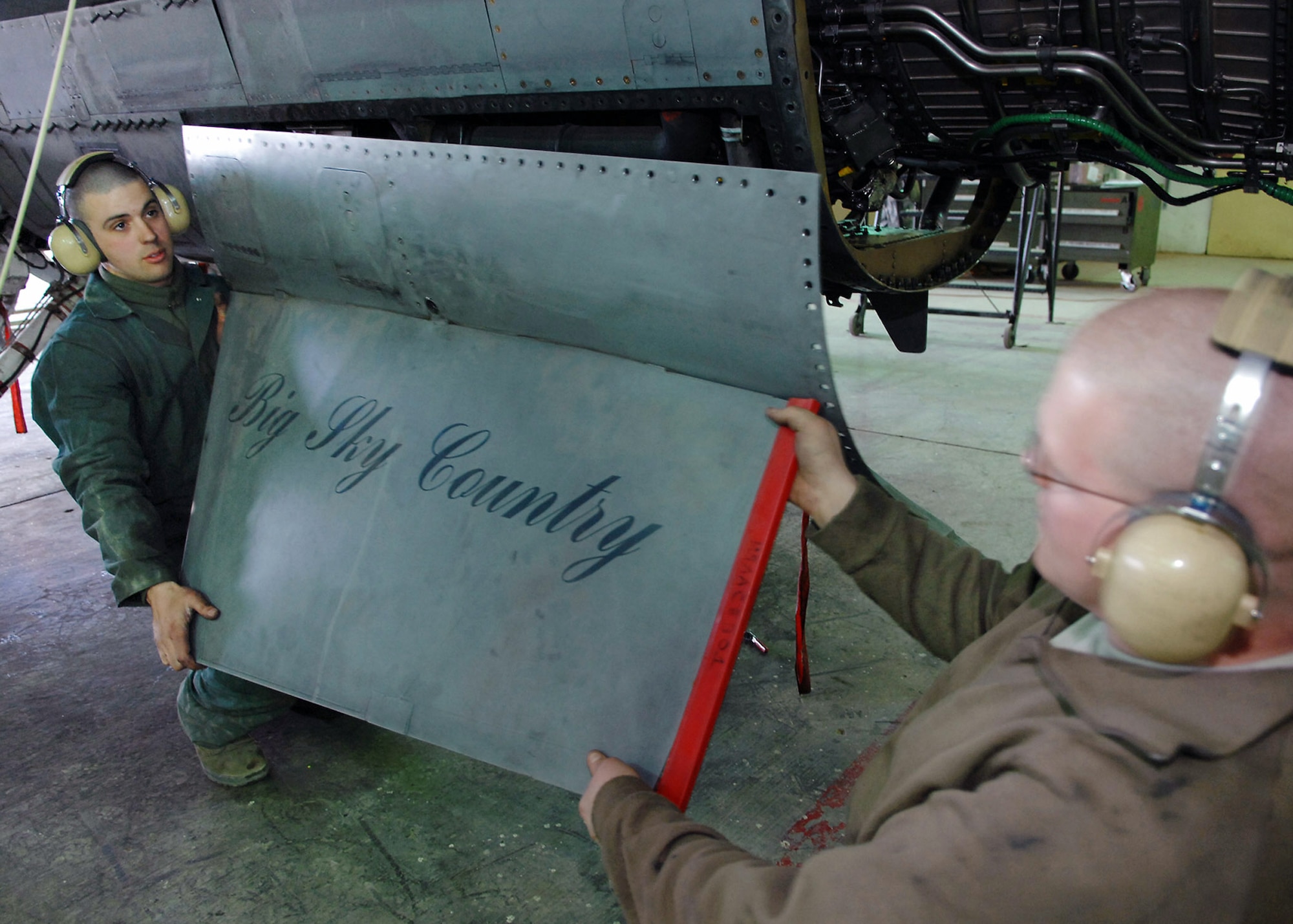 Senior Airmen Adam Fink and Christopher Jaeger remove the left ventral fin of an F-16 Fighting Falcon Feb. 22 at Balad Air Base, Iraq. During a phase inspection, all panels and covers are taken off of the aircraft for preventative maintenance on the aircraft systems and equipment. The aircraft crews fly missions in support of Operation Iraqi Freedom. Both Airmen are 332nd Expeditionary Maintenance Squadron crew chiefs deployed from the Wisconsin National Guard. (U.S. Air Force photo/Senior Airman Julianne Showalter) 