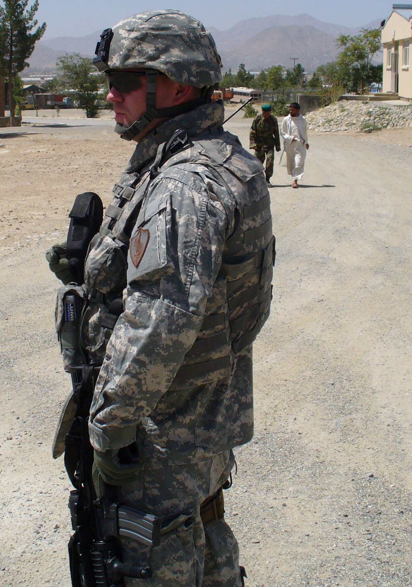 Tech. Sgt. Samuel Schmitz, contingency skills instructor from the U.S. Air Force Expeditionary Center's 421st Combat Training Squadron at Fort Dix, N.J., participates in a patrol in a village near Kabul, Afghanistan, July 28, 2007 during his deployment there.  Sergeant Schmitz, an Air Force civil engineering power production specialist, deployed as an Afghan National Army Central Movement Agency Mentor from January 2007 to February 2008.  (U.S. Air Force Photo)