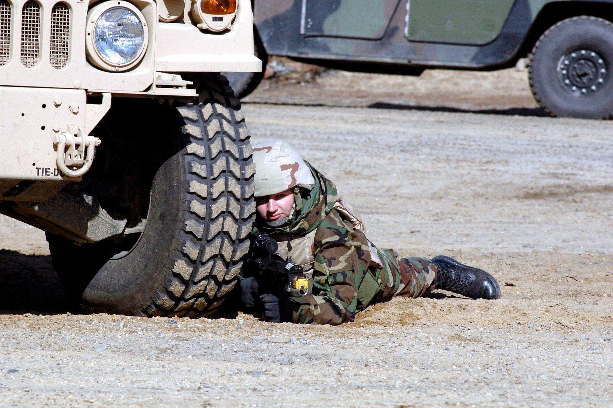 Airman 1st Class Rachel Debolt takes up a defensive position during a scenario for training for the course Feb. 20 on a range at Fort Dix, N.J. The course is taught by members of the Air Force Expeditionary Center's Expeditionary Operations School and 421st Combat Training Squadron, and the course prepares security forces Airmen for upcoming deployments. Airman Debolt is a 569th United Sates Forces Police Squadron, Vogelweh Air Base, Germany, and a student in the Air Force Phoenix Warrior Training Course 08-3. (U.S. Air Force photo/Tech. Sgt. Scott T. Sturkol)
