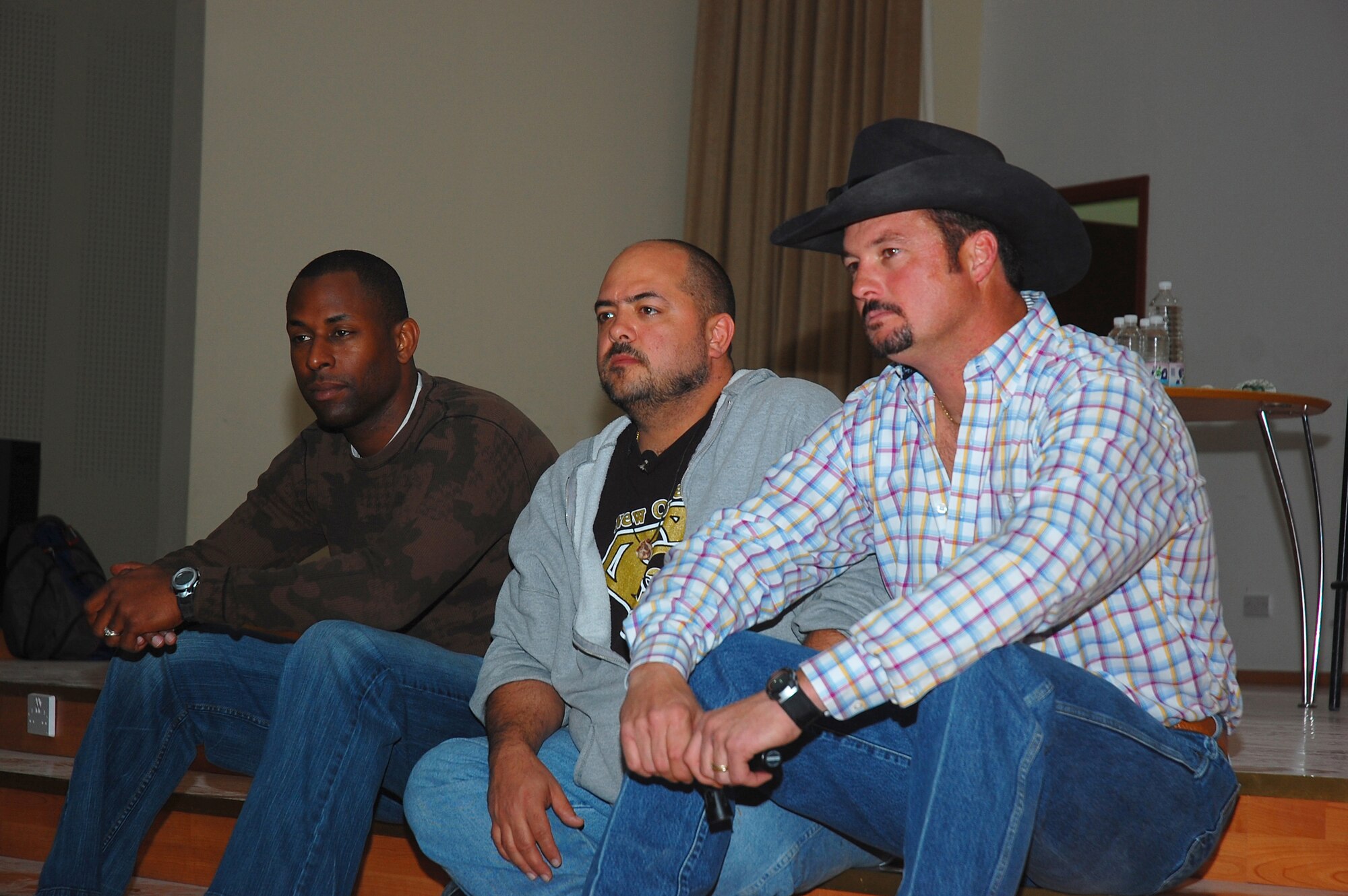 SOUTHWEST ASIA -- Comedians (left to right), Danta 'Touchee' Jackson, 'Wild' Bill Dykes, and 'The Cowboy Comedian,' listen to a question during an interview prior to their show Feb. 26, 2008 at an air base in the Persian Gulf Region. The comedians are on their Multi-National Corps Iraq, Army Morale Welfare Recreation, Lone Wolf Entertainment Comedy Tour 2008 which provides entertainment to deployed troops in support of Operations Enduring and Iraqi Freedom. (U.S. Air Force photo/ Staff Sgt. Patrick Dixon) 