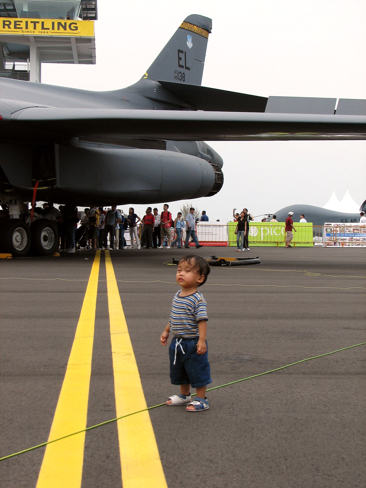 Eighteen-month-old Aryandana Yudono explores the Department of Defense aircraft pavilion Feb. 23 during a public day at the 2008 Singapore Air Show. Born in Chicago, Aryandana was attending the air show with his parents who recently relocated to Singapore. Seven U.S. military aircraft were on display at the air show including a B-1B Lancer, F-15 Eagle, F-16 Fighting Falcon and F/A-18 Super Hornet, a KC-135 Statotanker and C-130 Hercules aircraft. (U.S. Air Force photo/Senior Master Sgt. Charles Ramey) 
