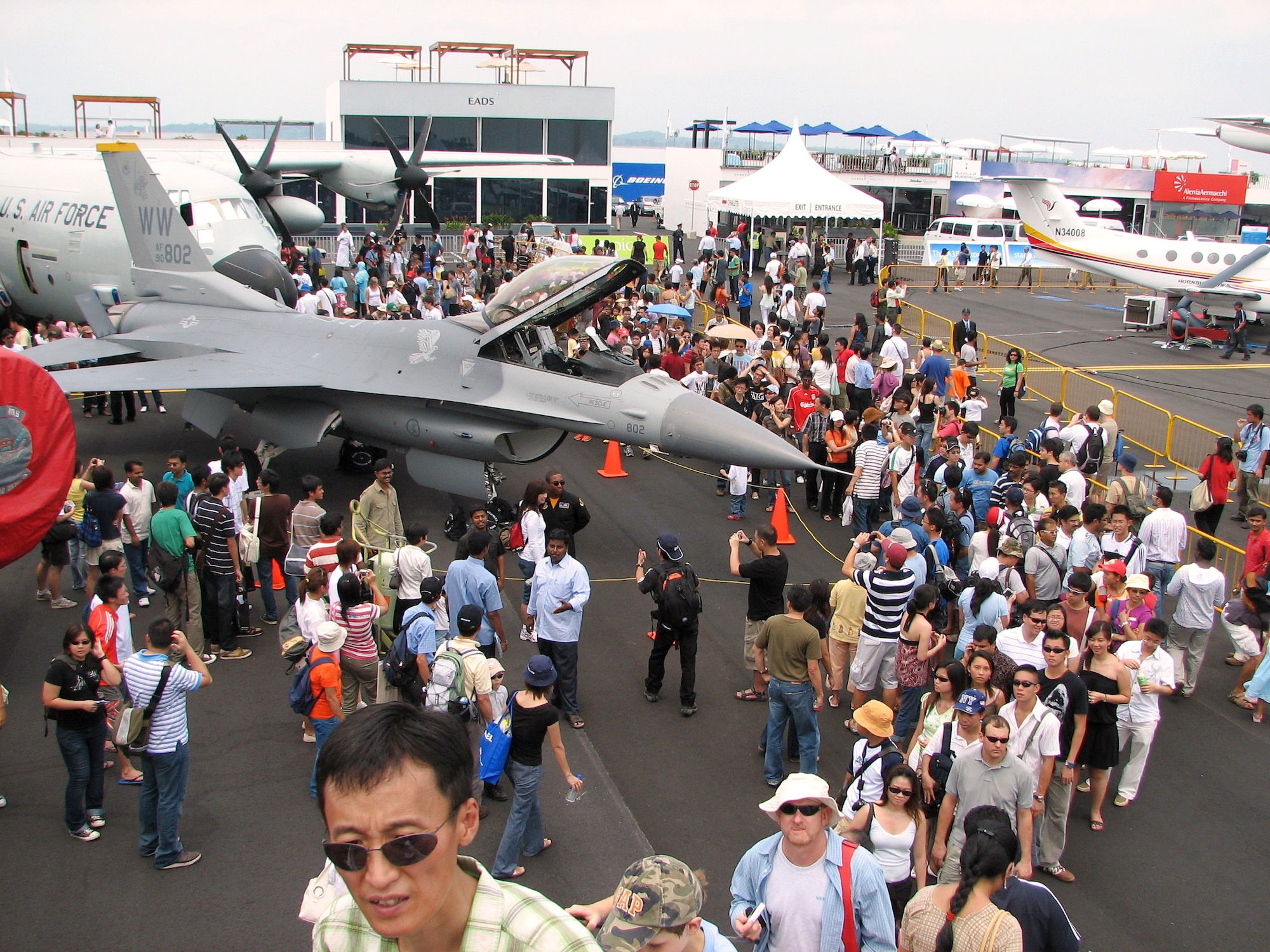Crowds gather around an F-16 Fighting Falcon static display during a public day at the 2008 Singapore Air Show Feb. 23. The F-16 is assigned to the 35th Fighter Wing, Misawa Air Base Japan. In addition to the static display, the Pacific Air Forces F-16 Demonstration Team and Pacific Fleet's F/A-18 Super Hornet Demonstation Team performed at the air show. A total of seven aircraft were on static display. (U.S. Air Force photo/Senior Master Sgt. Charles Ramey) 